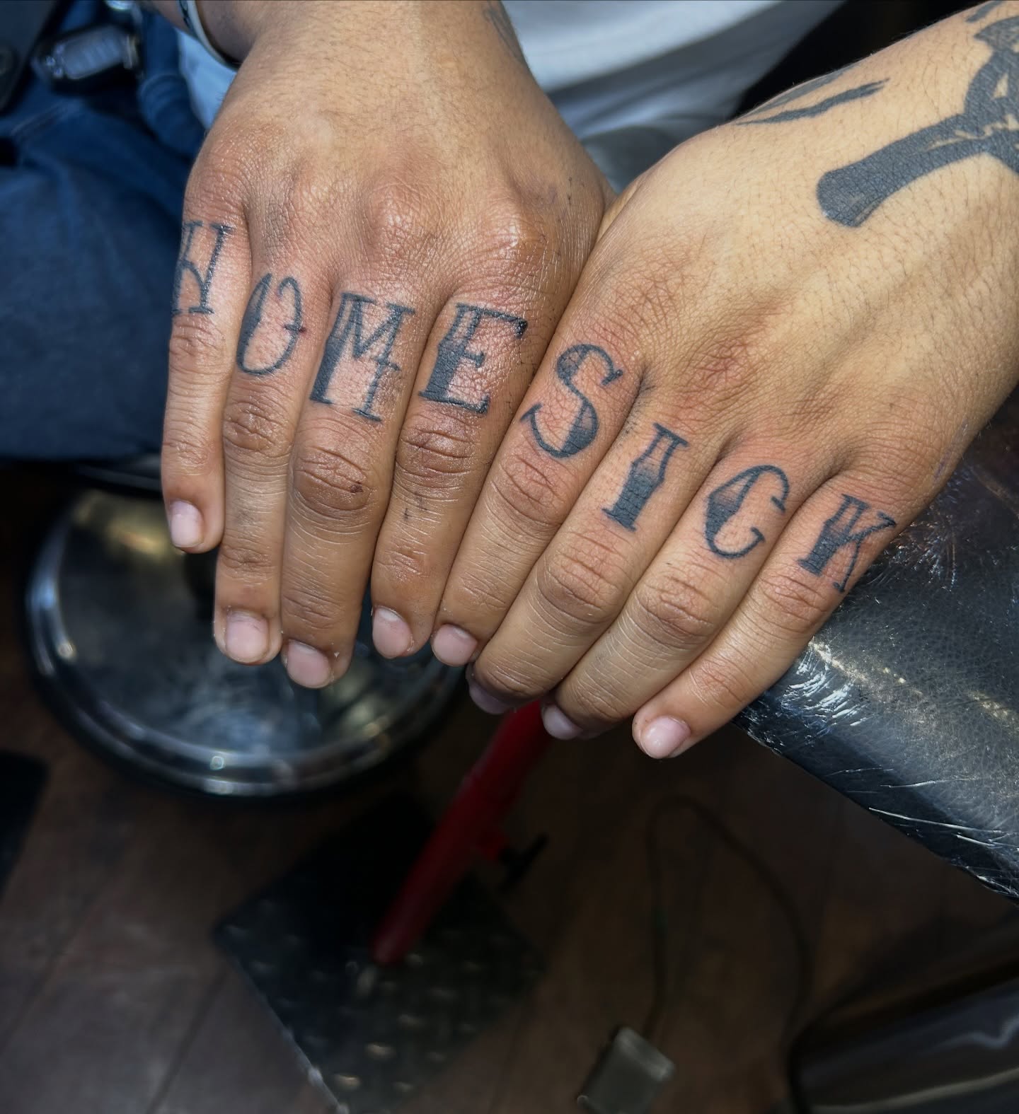 HOMESICK lettering script tattoo on the hand by Tattoos by Corey aka MrLu