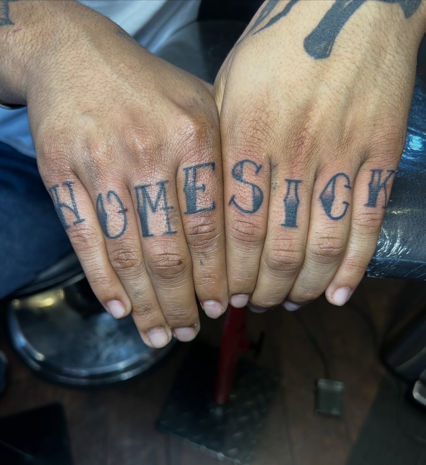 Homesick lettering script tattoo on the hand by Tattoos by Corey aka MrLu