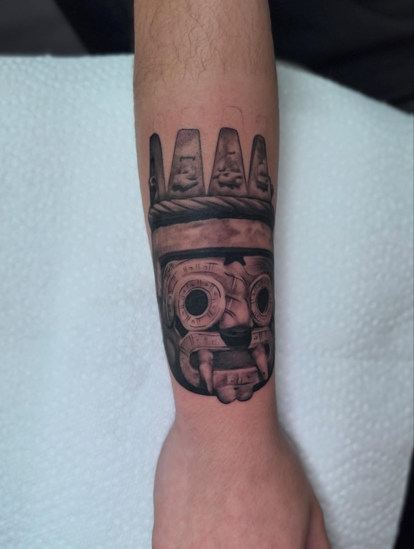 Ancient mask realism tattoo on the forearm by Tattoos By Chico