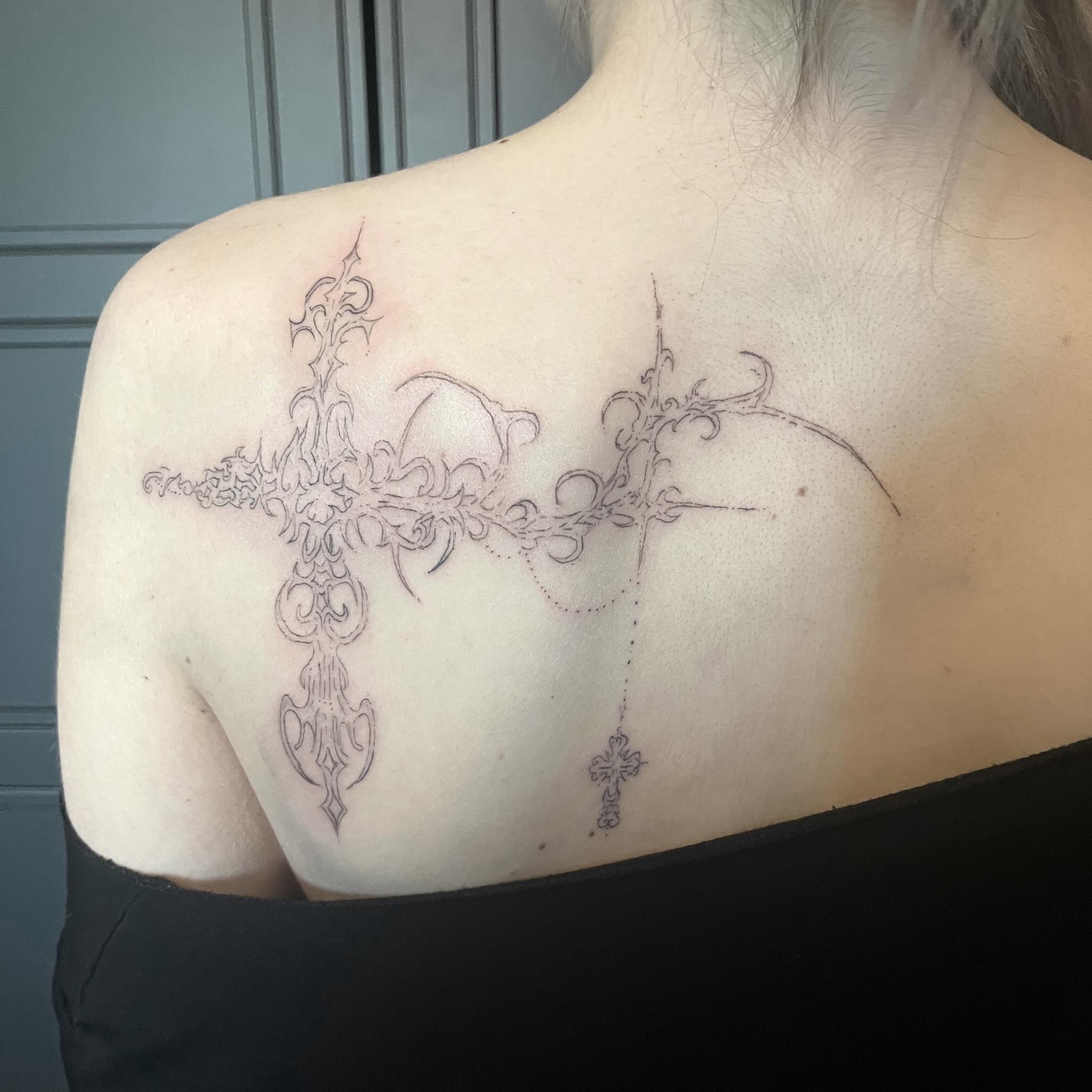 Cross black and grey tattoo on the shoulder by kacper