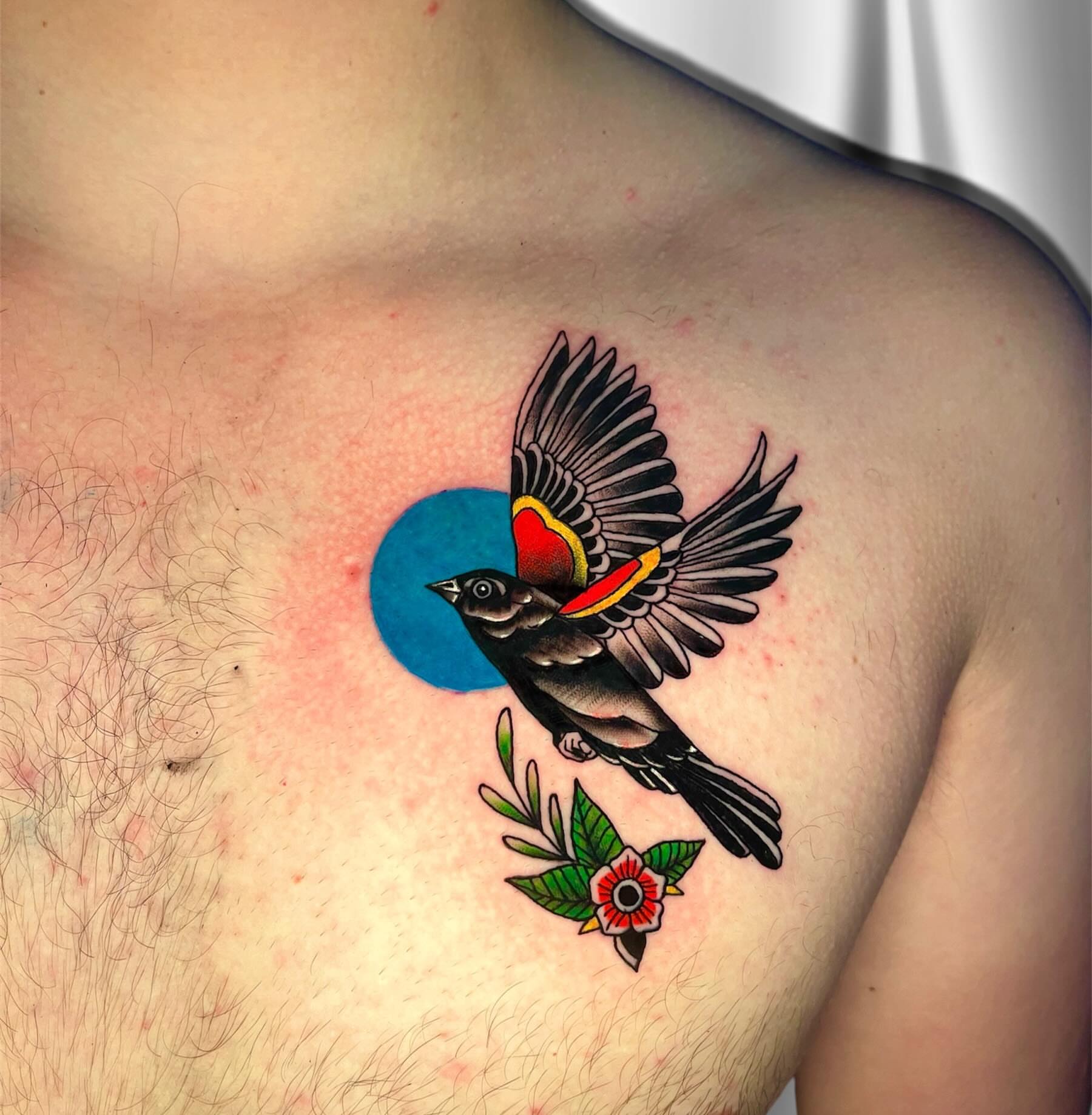Bird and flower American traditional tattoo on the chest by Brooke Kresco