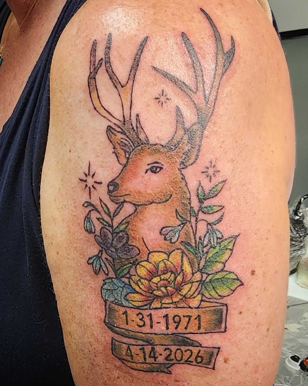 Deer with flowers and dates tattoo on the shoulder by Anntonietta Borzacchiello