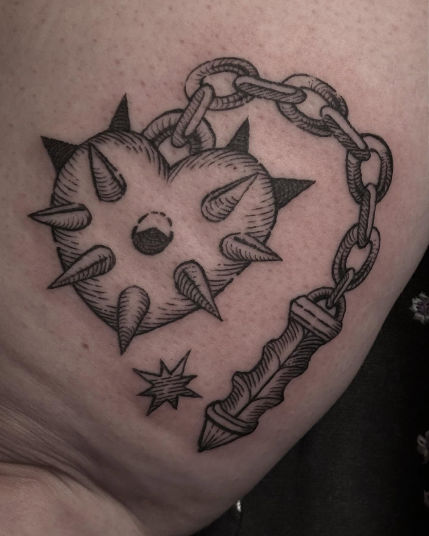 Spiked heart with chain black and grey tattoo on the chest by Christian