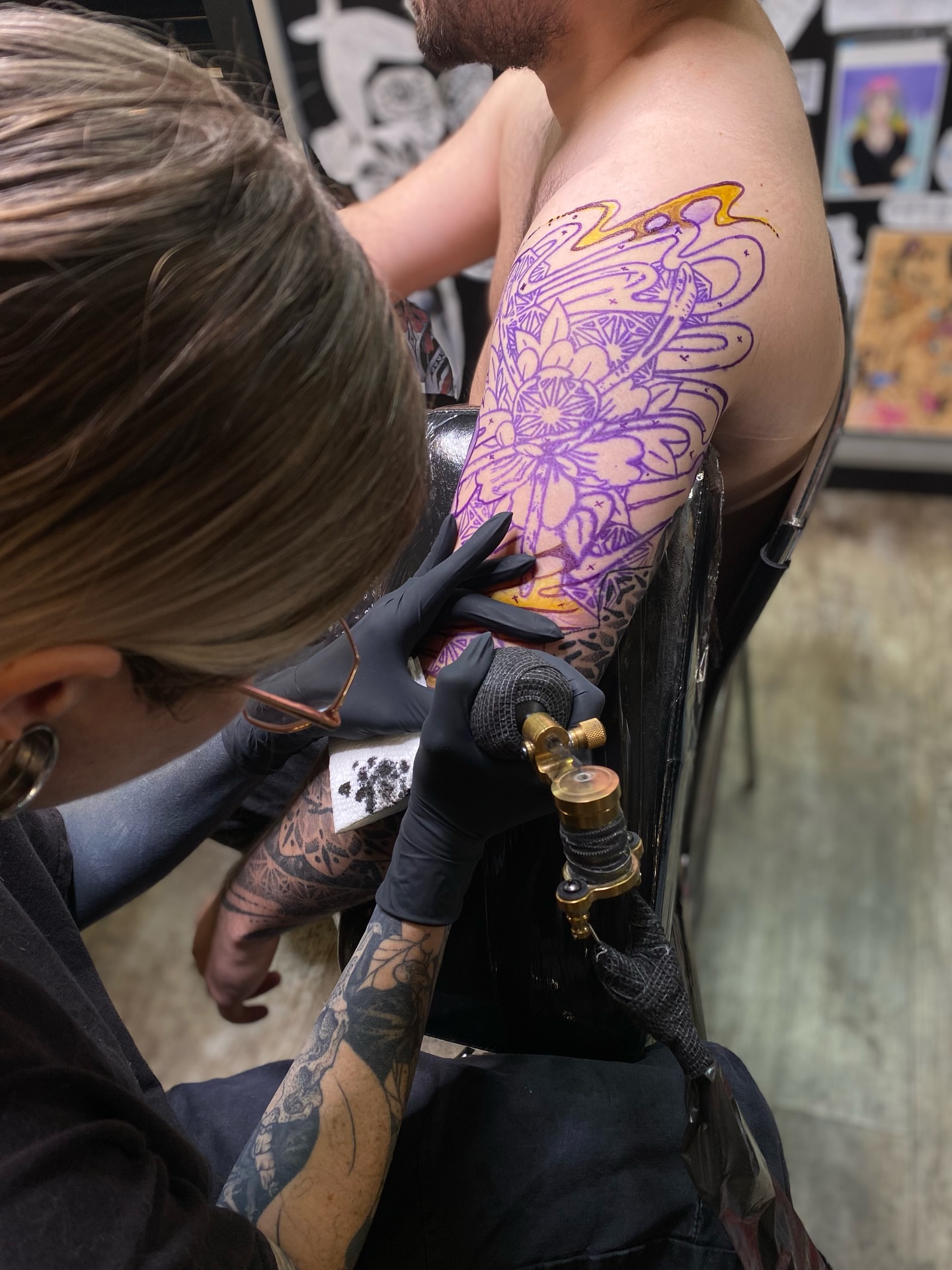 Floral mandala geometric tattoo on the upper arm by Emily Miller