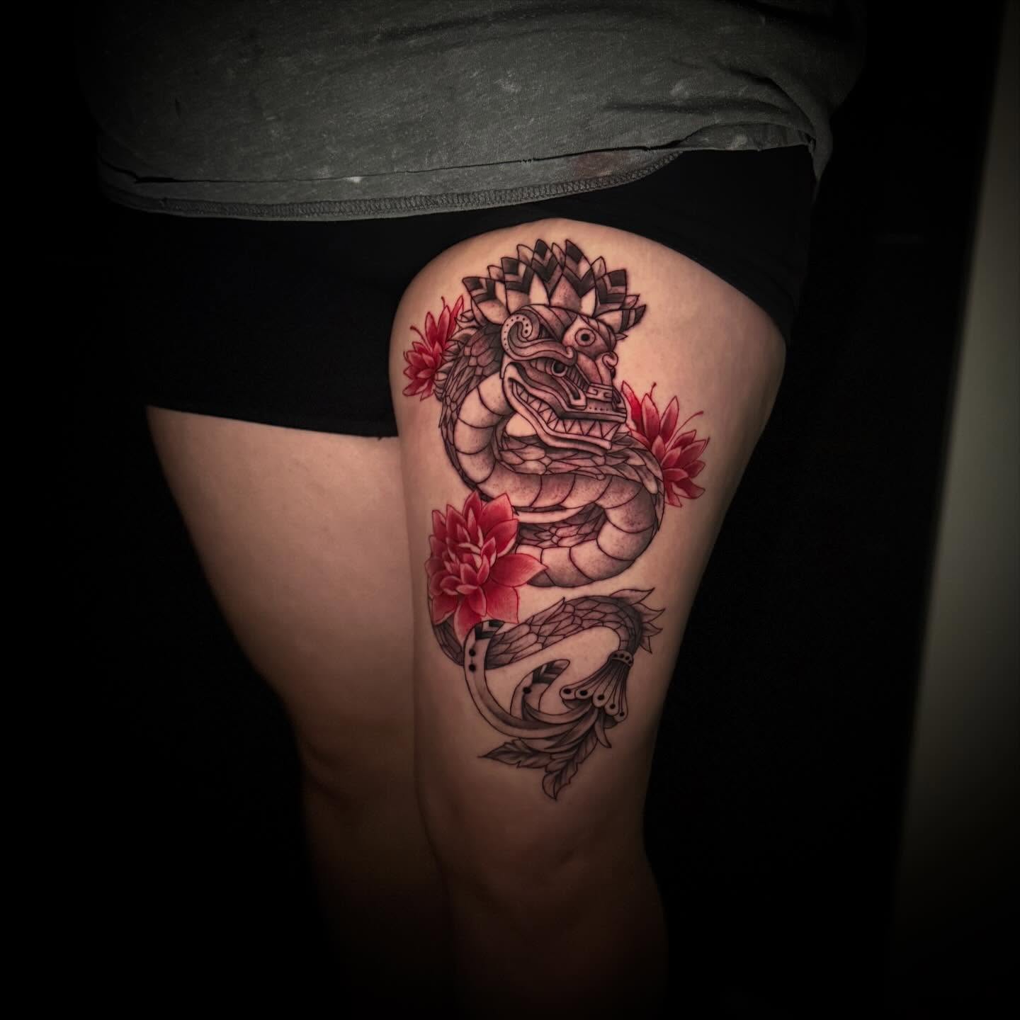 Dragon and flowers American traditional tattoo on the thigh by Sad Girl Tattoos