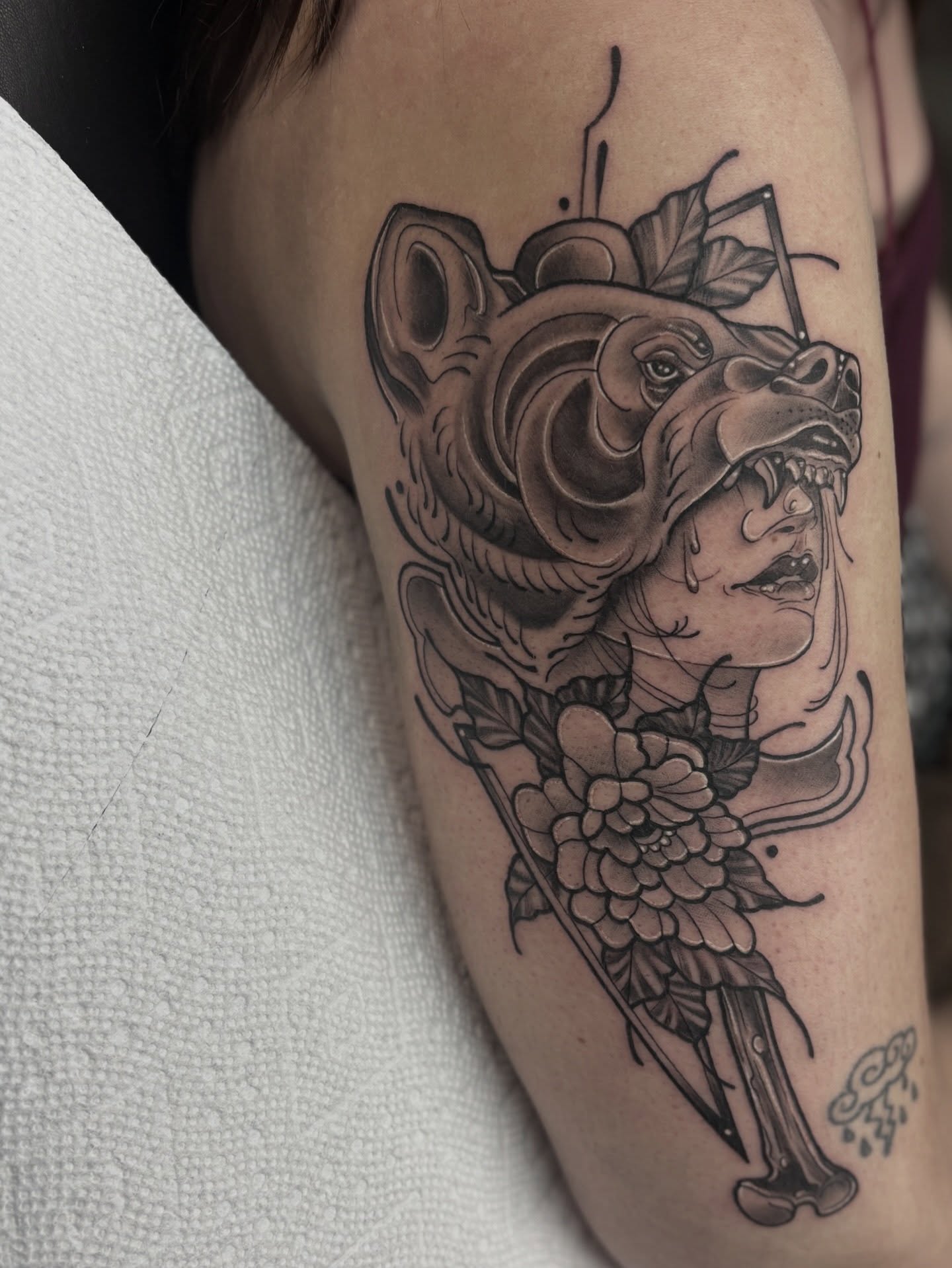 Bear and flower realism tattoo on the forearm by Genevieve Ehlers, Denver, Colorado