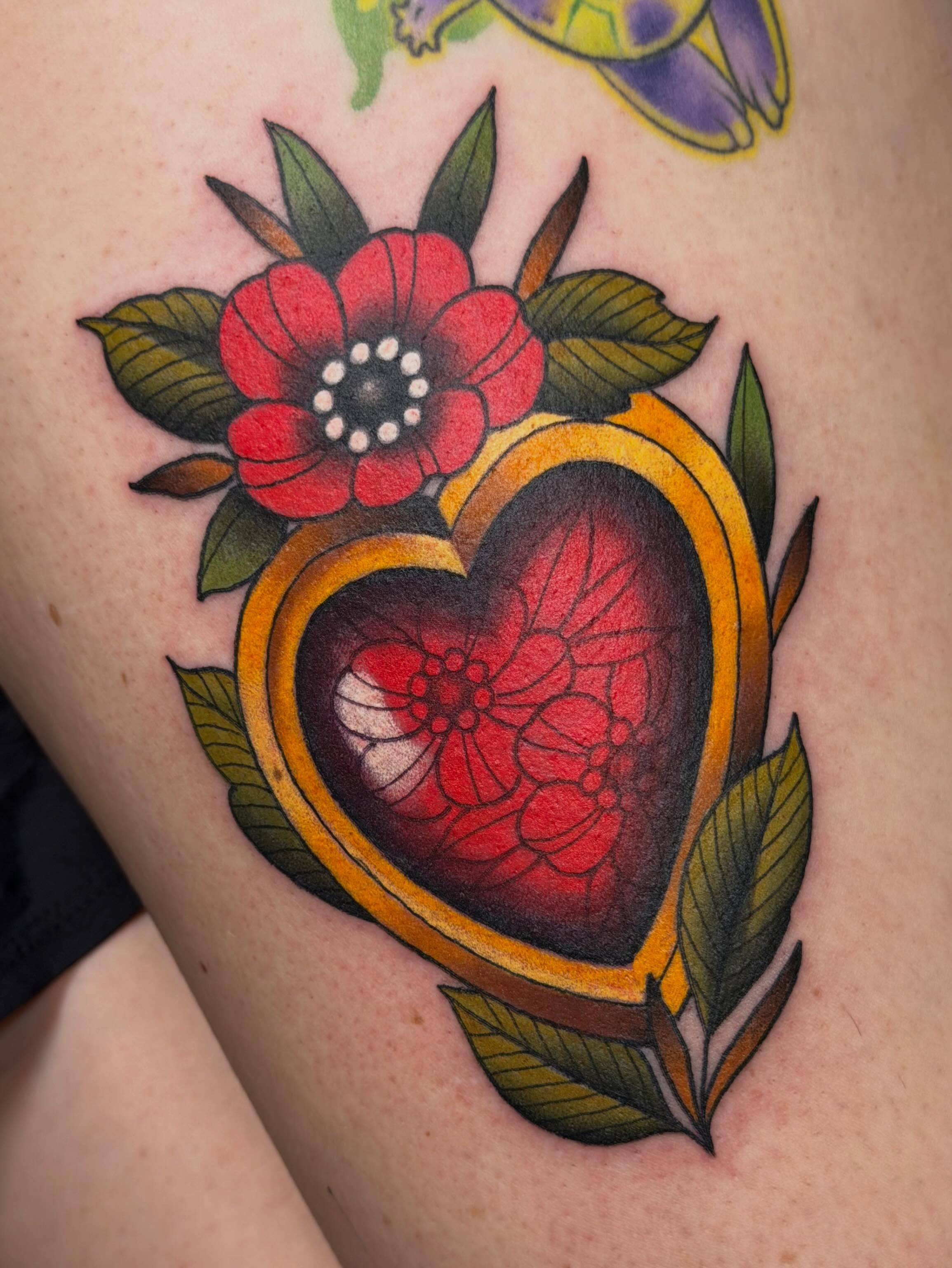 Heart with floral design American traditional tattoo on the thigh by ♥︎ ᴅᴇᴠ ʀᴇɴᴇᴇ ♥︎
