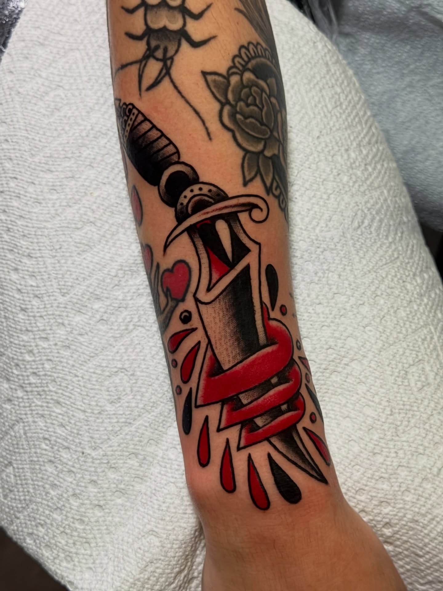 Sword and heart American traditional tattoo on the forearm by Brandon Bear