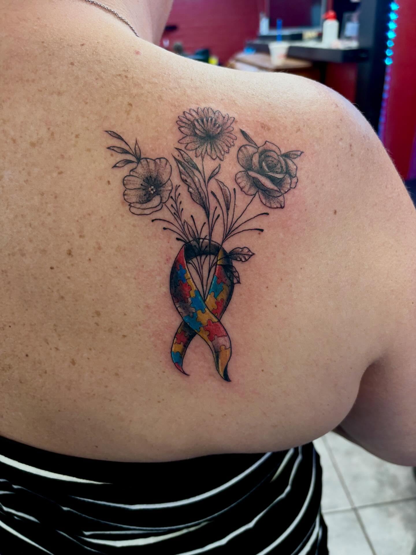 Autism awareness ribbon with flowers new school tattoo on the shoulder by Brandon Harrison, Kansas City, Missouri