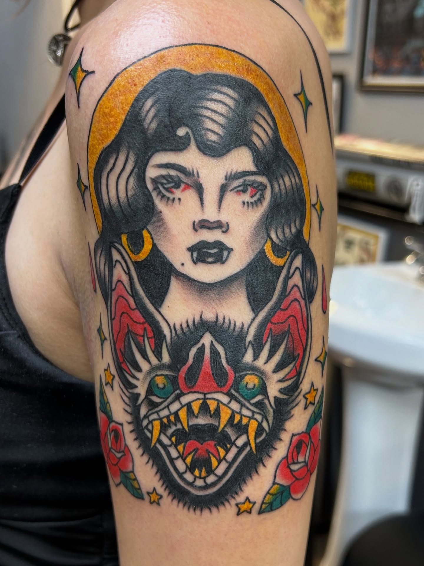 Woman with demon American traditional tattoo on the upper arm by Vivian Nguyen
