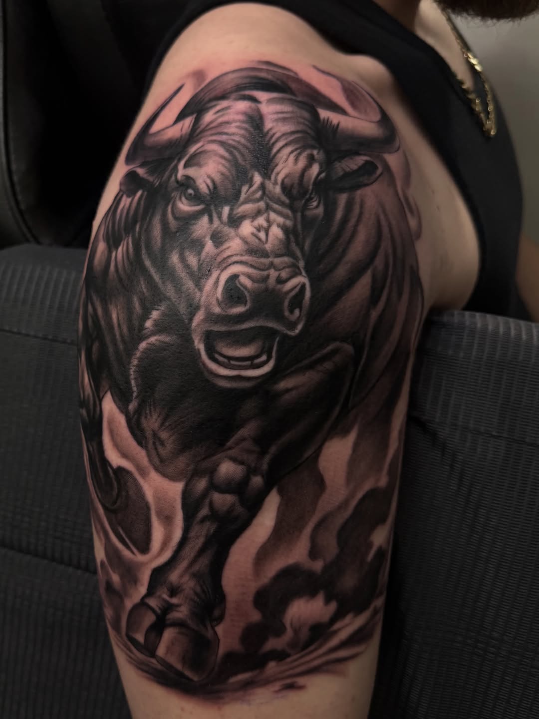 Charging bull realism tattoo on the shoulder by Eduardo Chaparro
