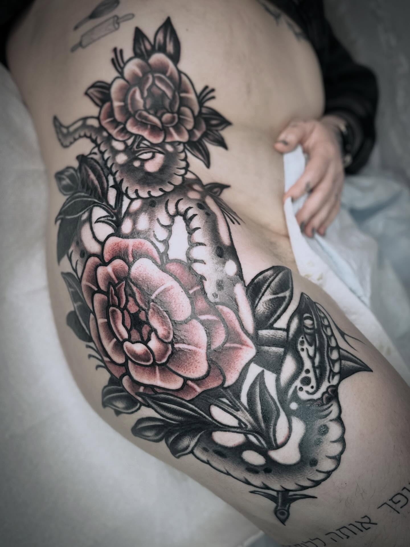 Peony and snake American traditional tattoo on the thigh by mia palau