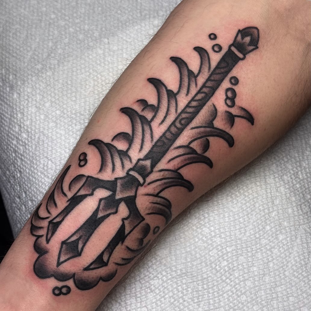 Sword and flame black and grey tattoo on the forearm by Larry Love