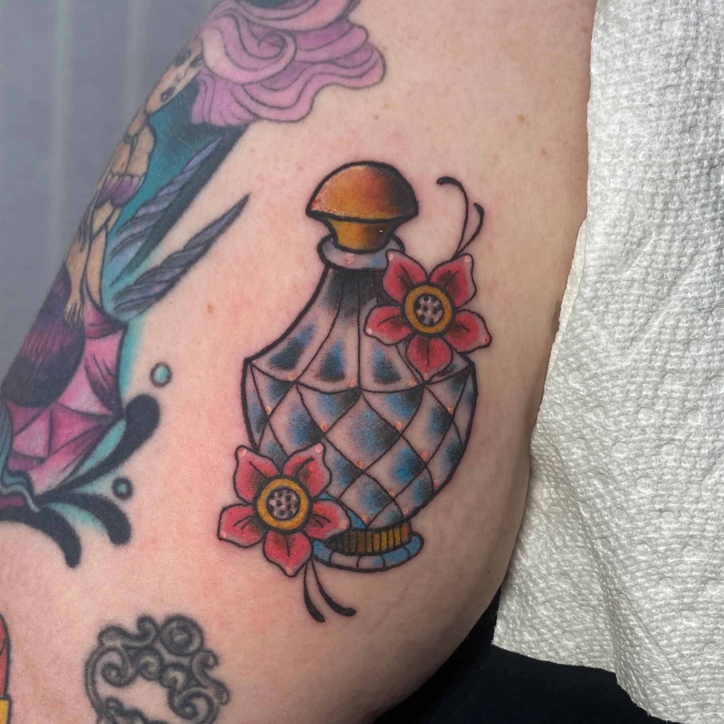 Perfume bottle geometric tattoo on the forearm by Mike Gorman - Portland Maine Tattoo Artist, Portland, Maine
