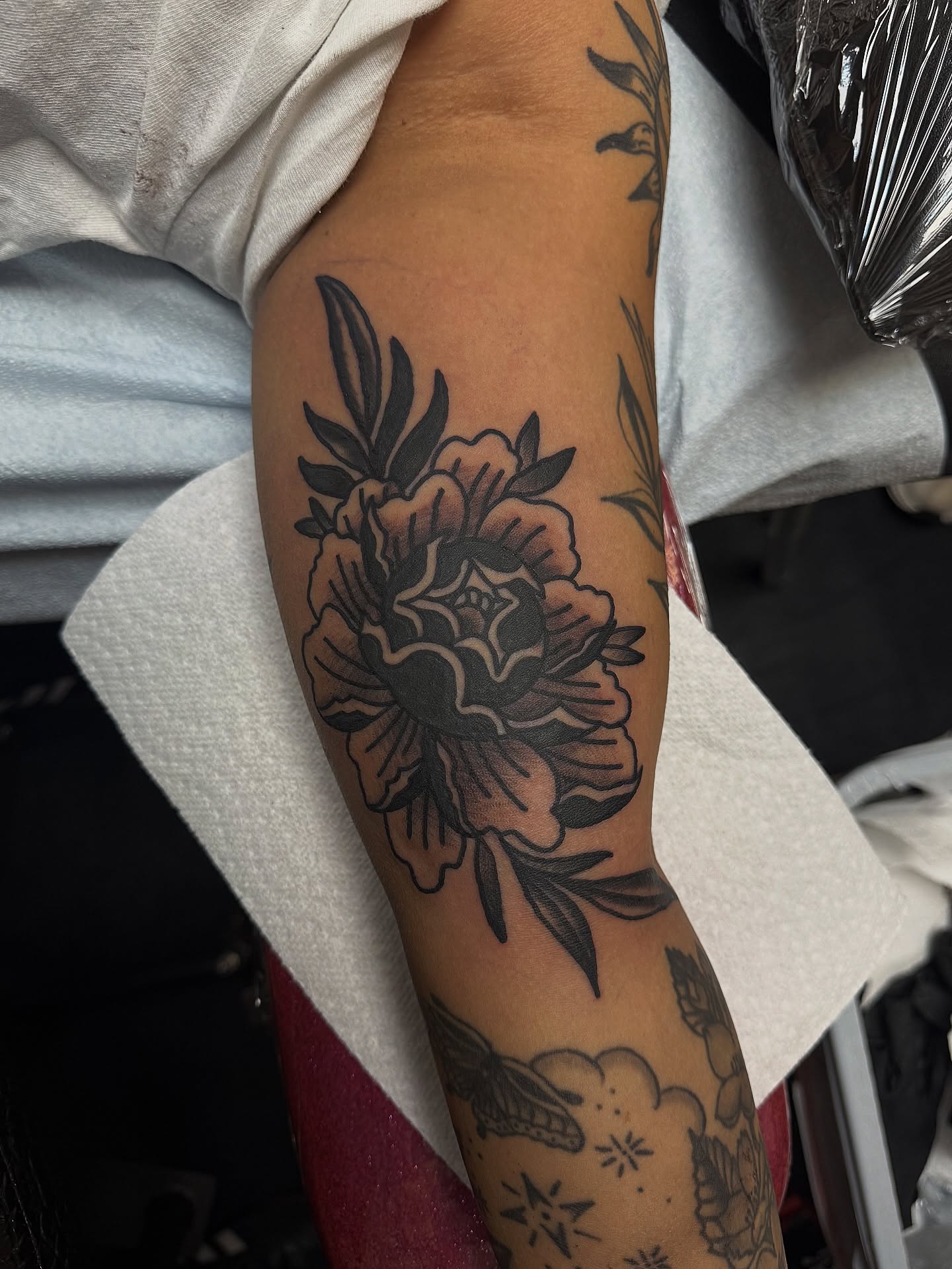 Peony flower black and grey tattoo on the forearm by @kevingaretz, Jersey City, New Jersey