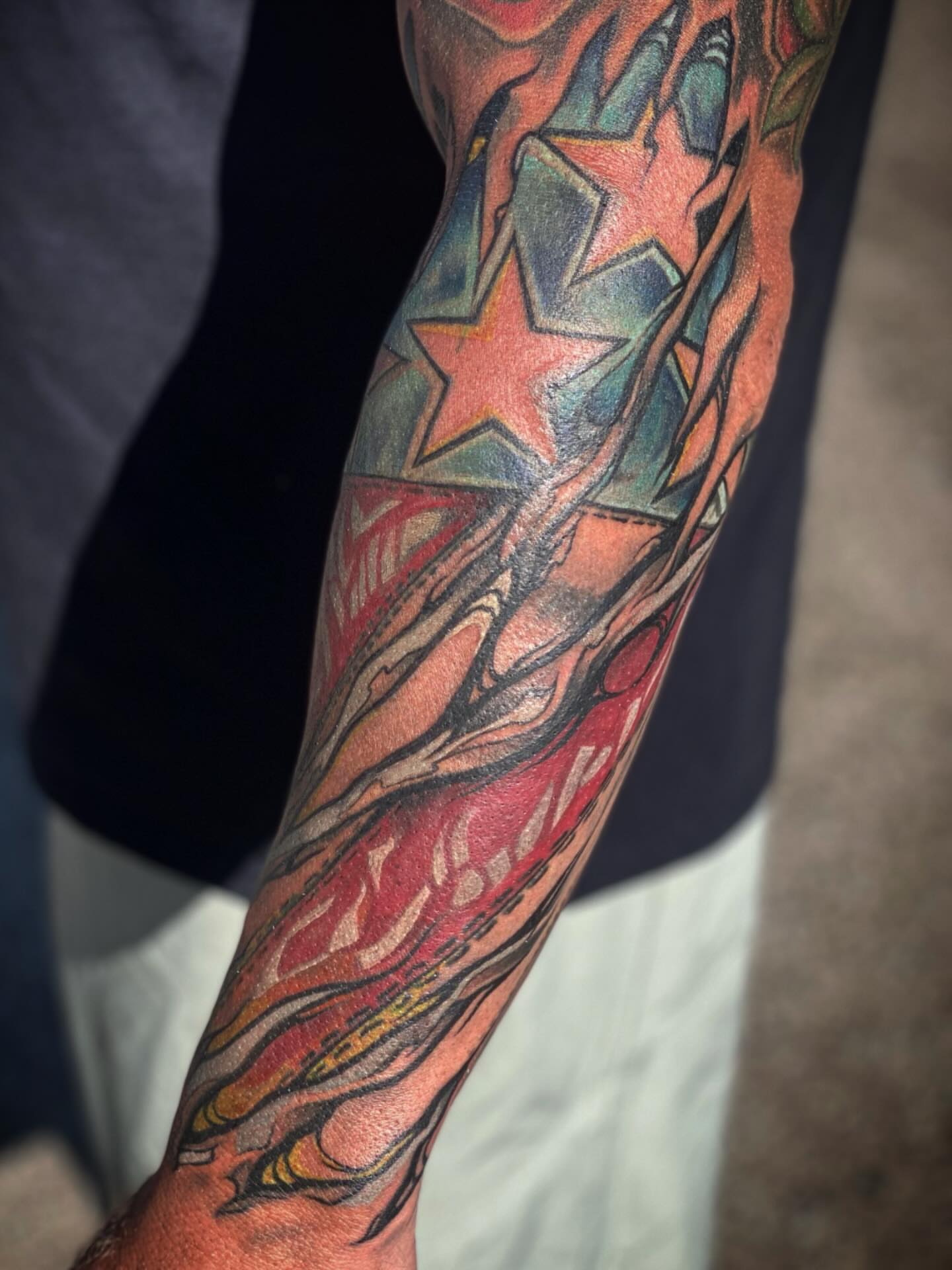 Stars and flames American traditional tattoo on the forearm by Chris Klee