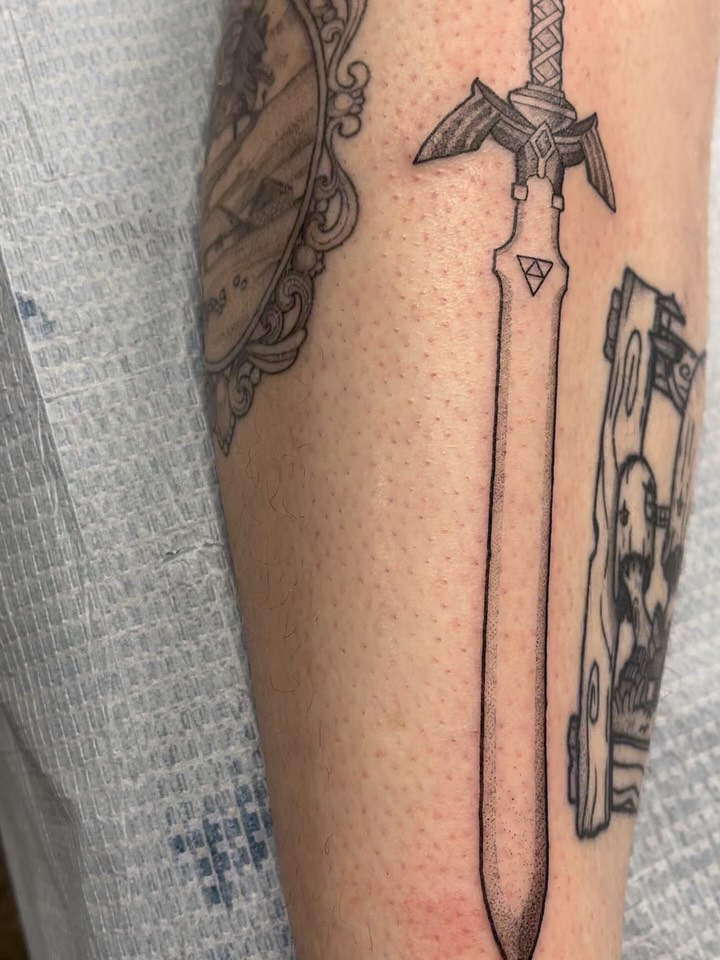 Sword black and grey tattoo on the forearm by bunny, Minneapolis, Minnesota