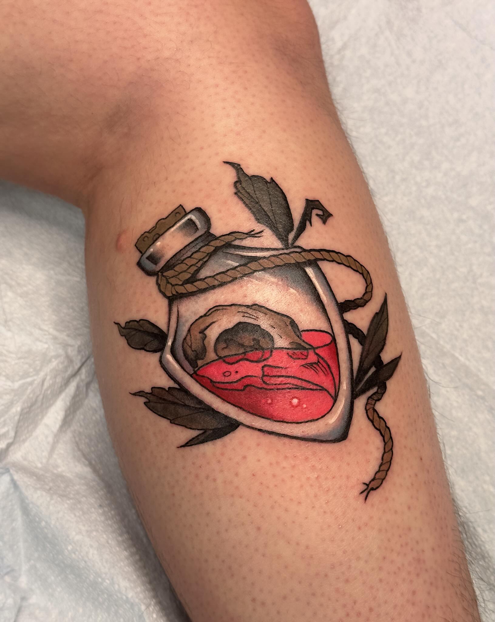 Glass bottle with skull American traditional tattoo on the forearm by Craig Ryans