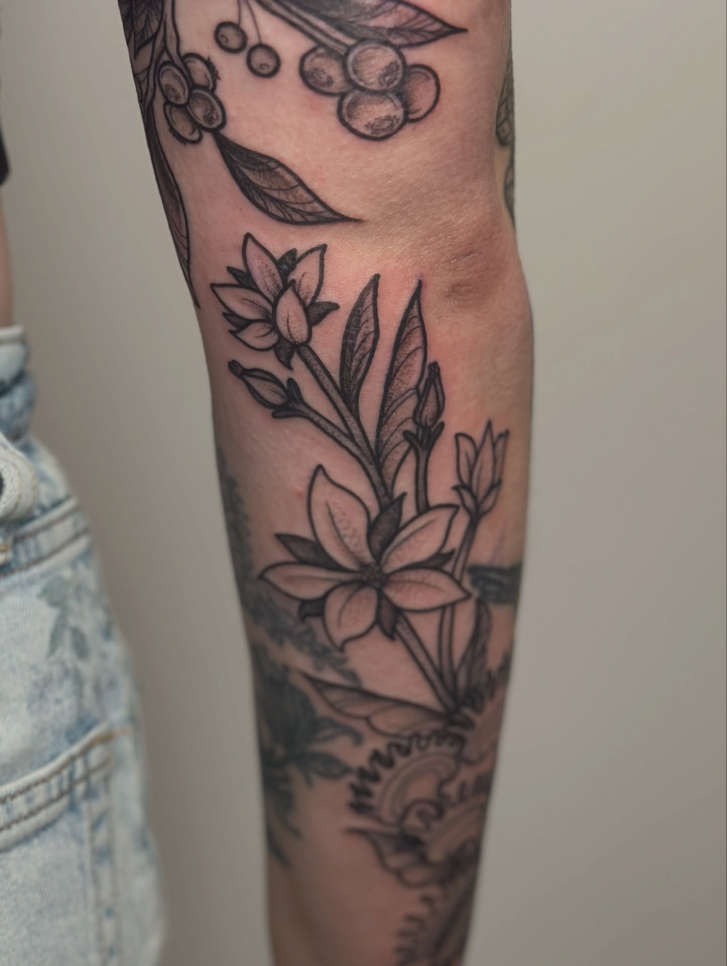 Flowers and leaves black and grey tattoo on the forearm by Gabrielle Brodman 🎀 Raleigh-Durham Tattoo