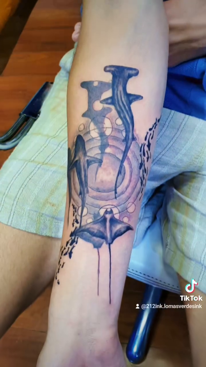 Lamp with chains and dripping ink fine line tattoo on the forearm by Tatuajes Betto Ink Tattoo