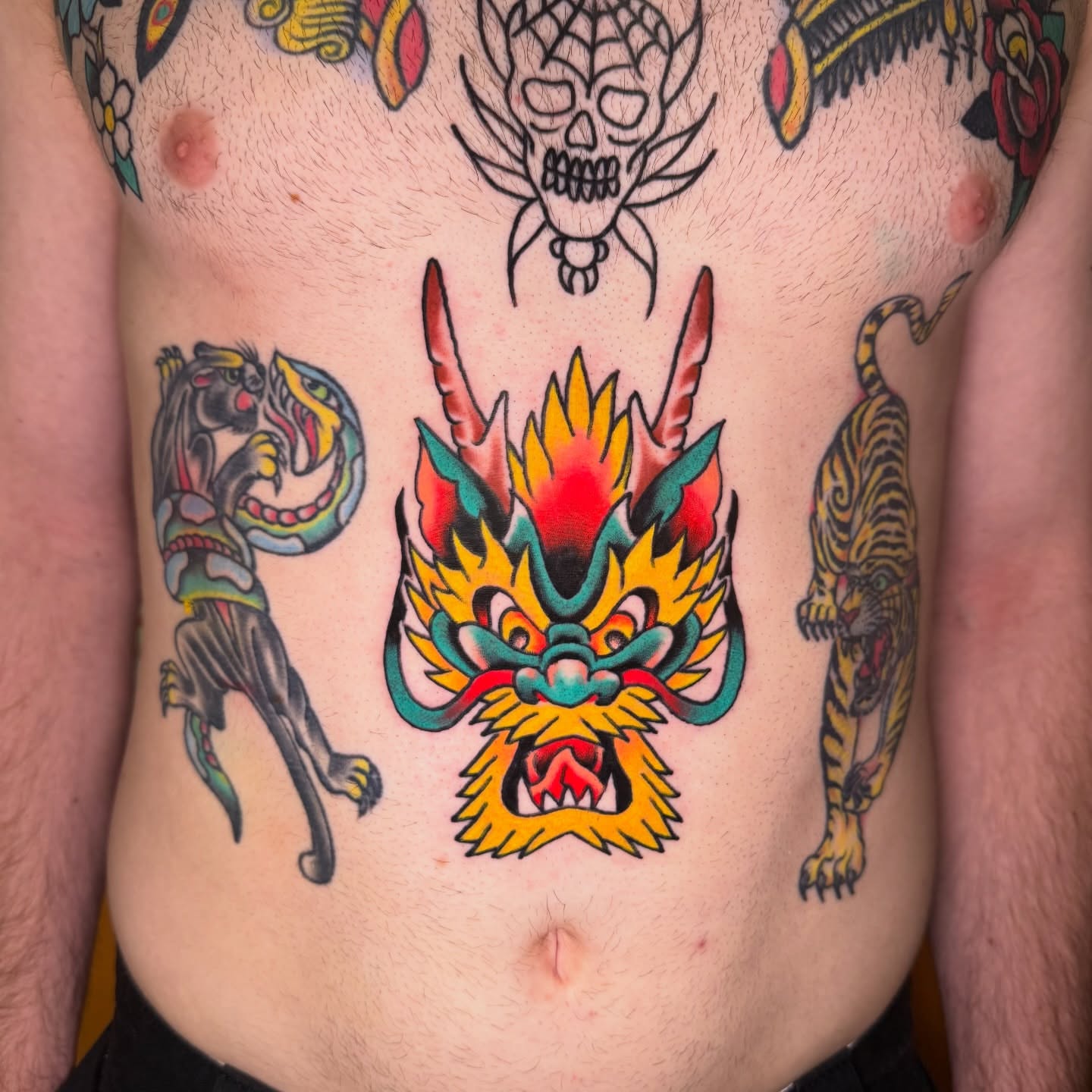 Dragon American traditional tattoo on the torso by Mike Dunn