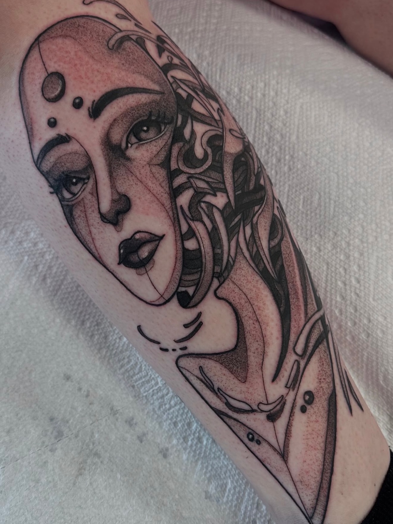 Woman's face dotwork tattoo on the forearm by Christopher Layman
