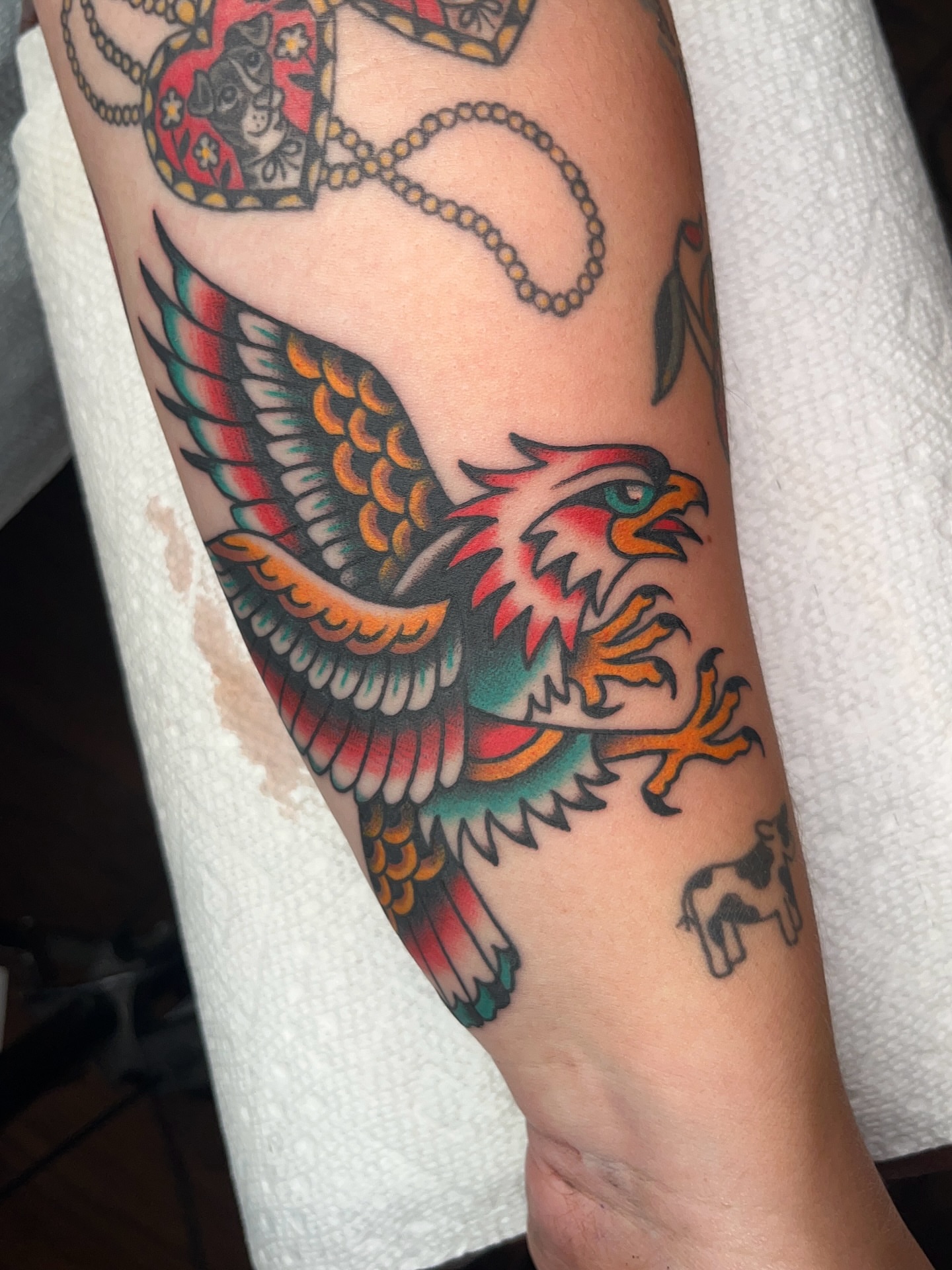 Eagle American traditional tattoo on the forearm by Nat Power