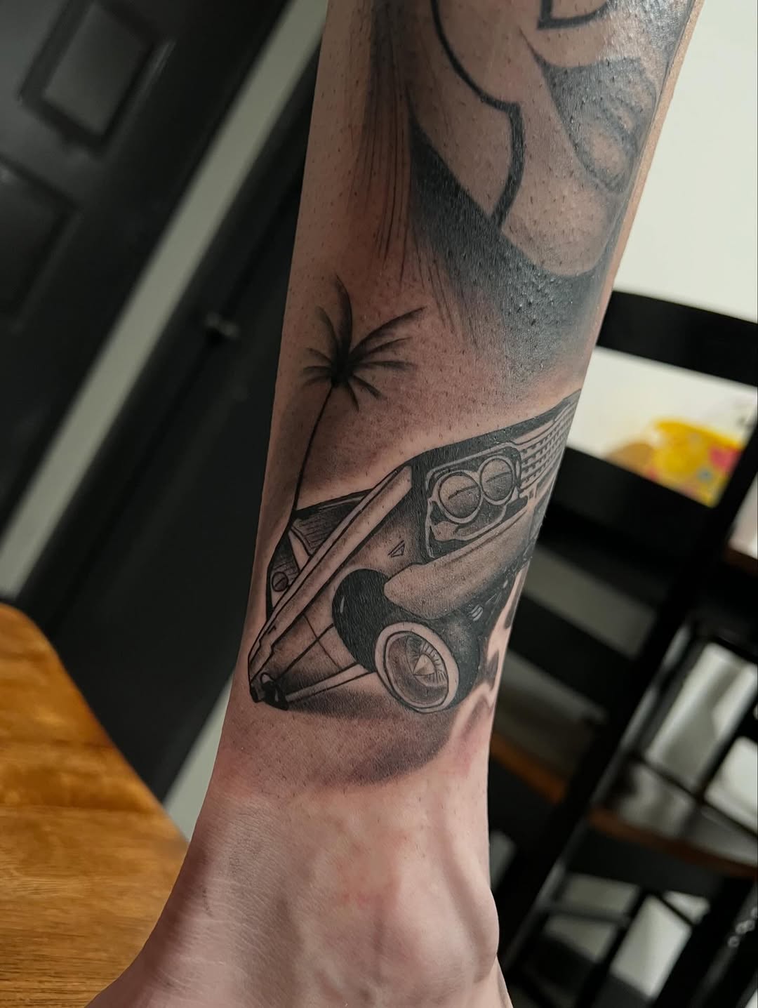 Lowrider car and palm tree realism tattoo on the forearm by Dallas tx tattoo artist ✝️