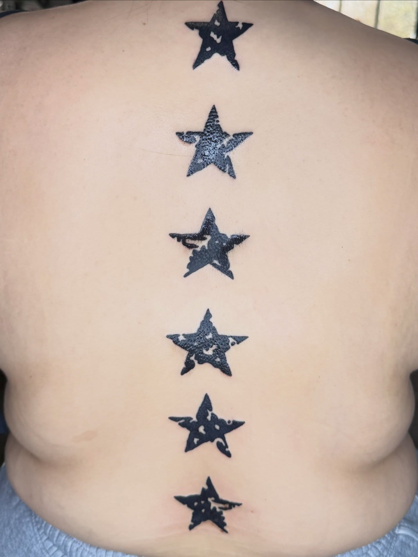 Stars black and grey tattoo on the back by @chrisskon, Carpentersville, Illinois