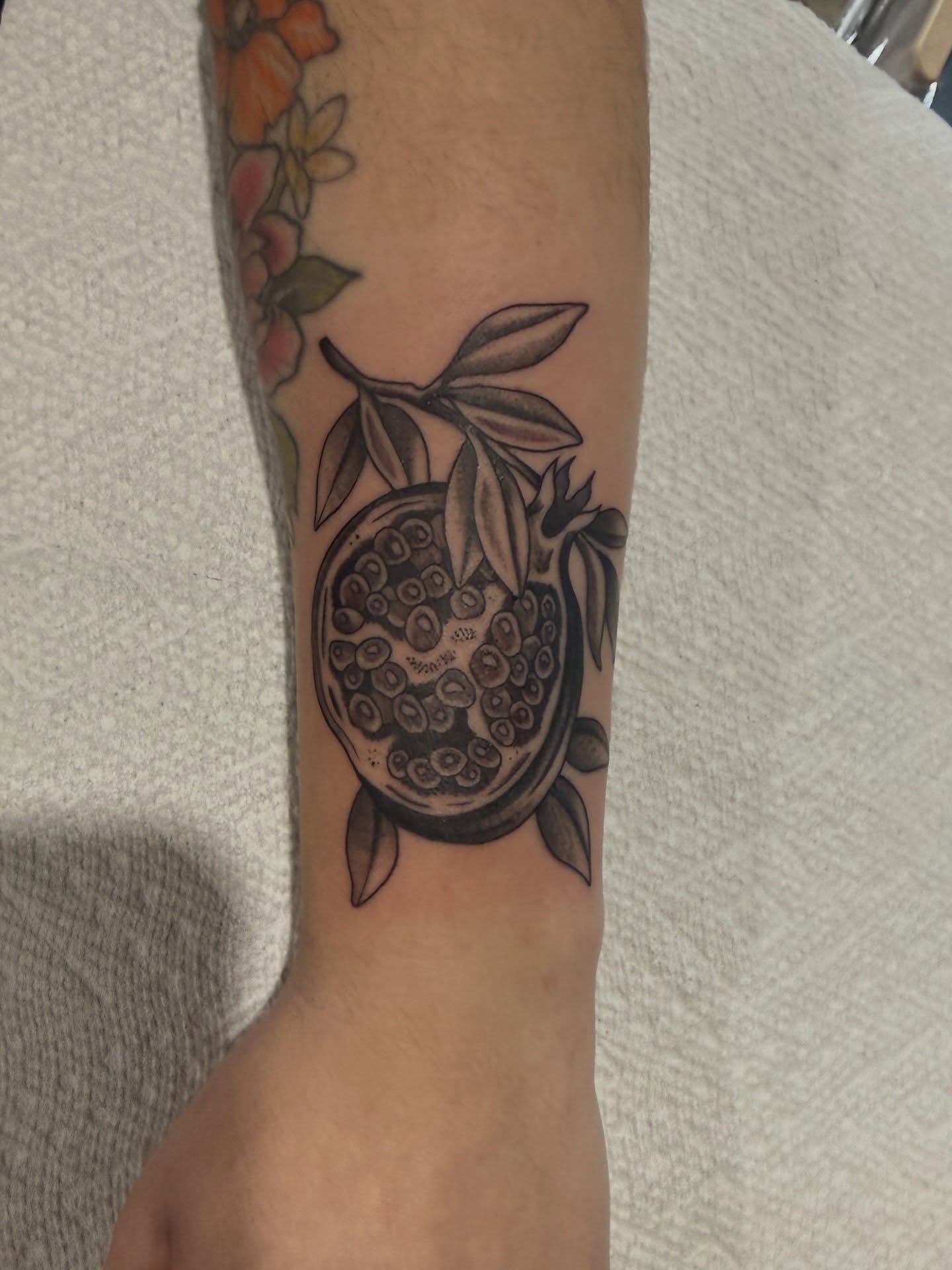Pomegranate black and grey tattoo on the forearm by @chrisskon, Carpentersville, Illinois