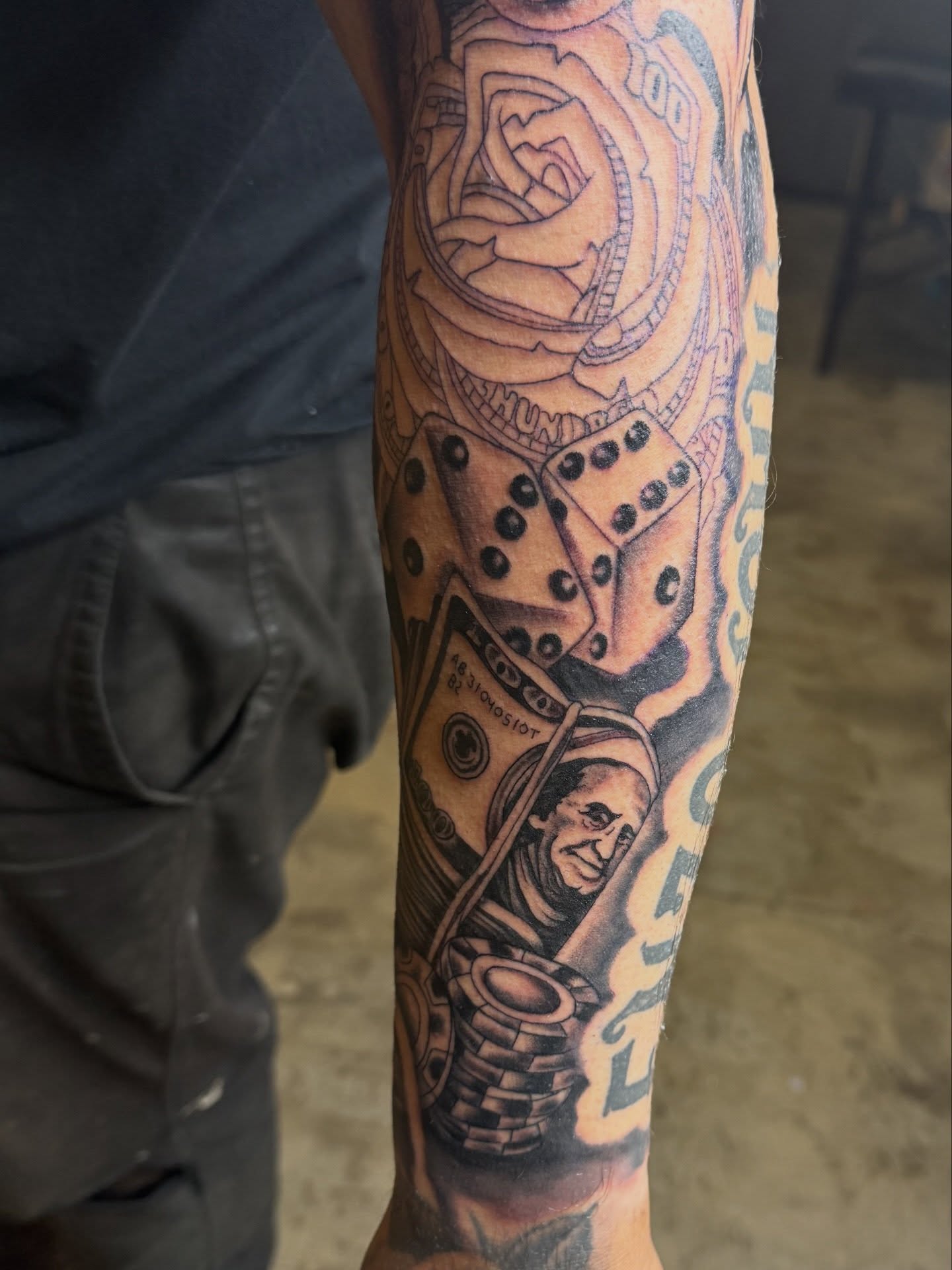 Dice and money realism tattoo on the forearm by @chrisskon, Carpentersville, Illinois