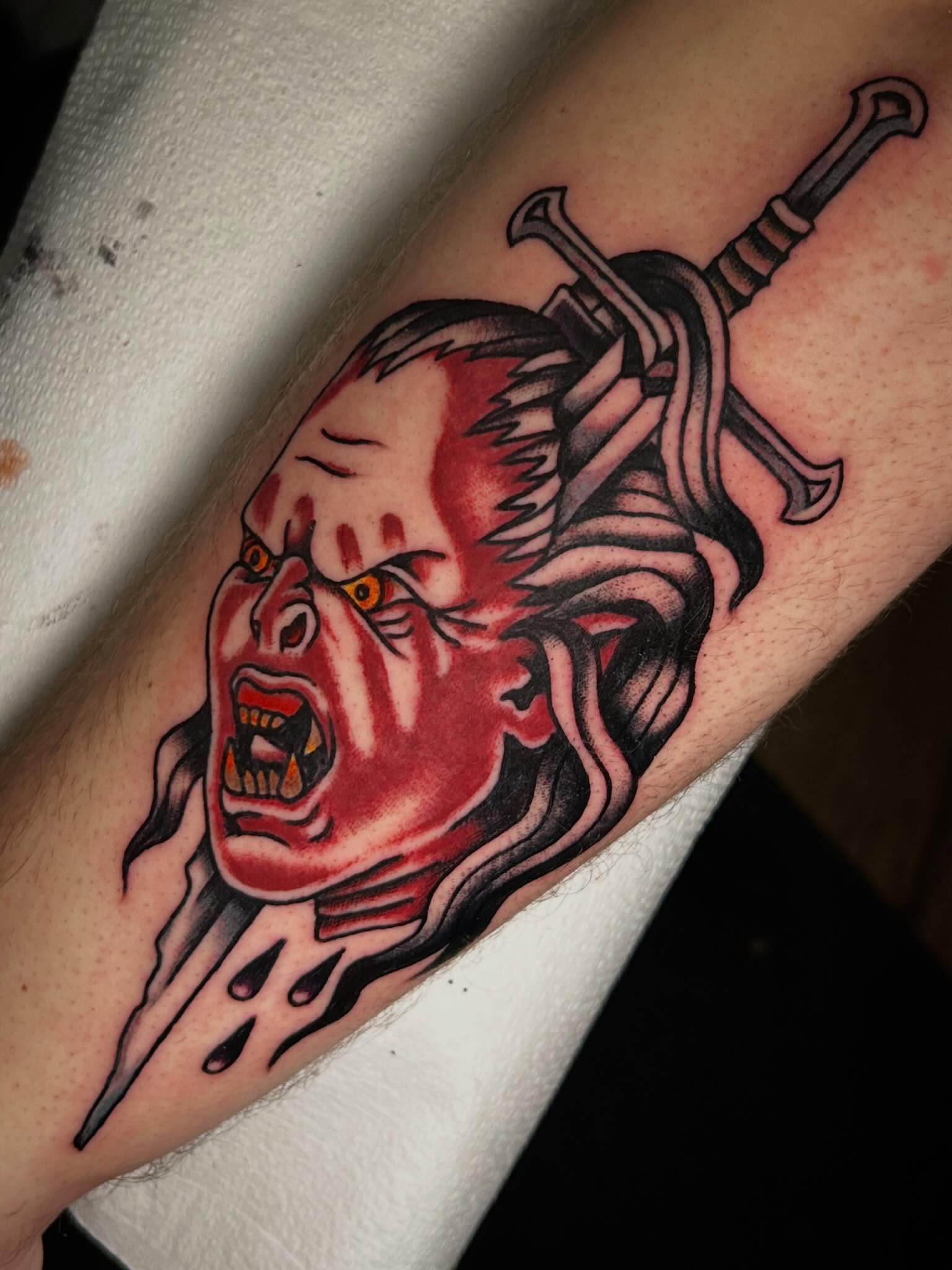 Medusa head with sword American traditional tattoo on the forearm by Morgan Mansfield
