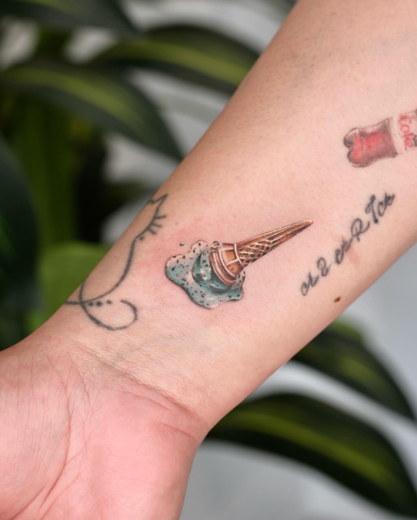 Ice cream cone melting realism tattoo on the forearm by Nina