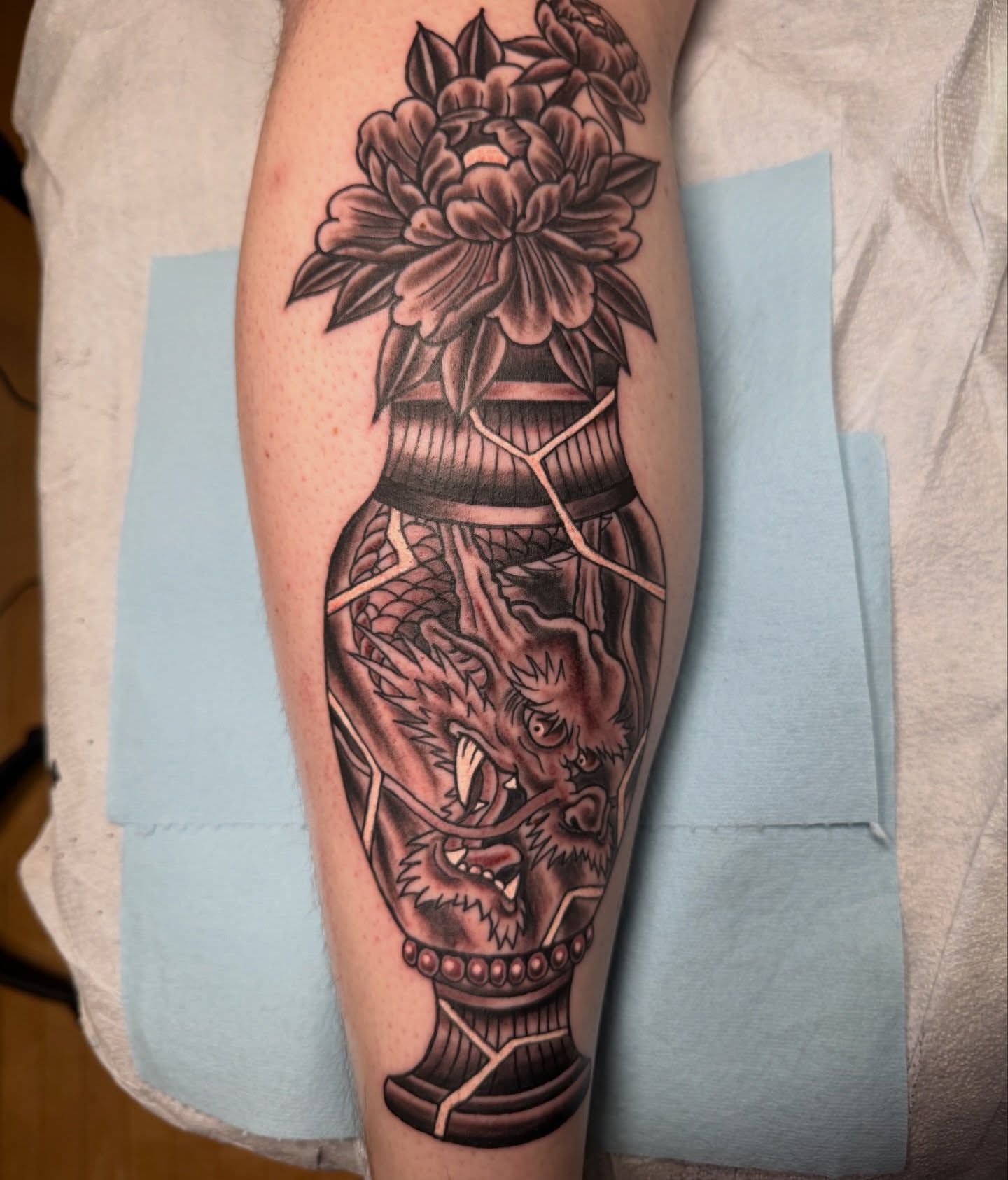 Dragon in vase American traditional tattoo on the forearm by Trevor Berry