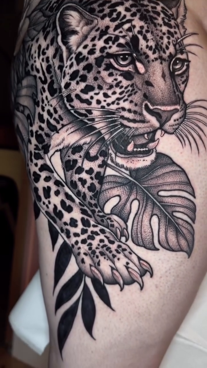 Leopard with flowers and butterflies realism tattoo by Luna Lucero