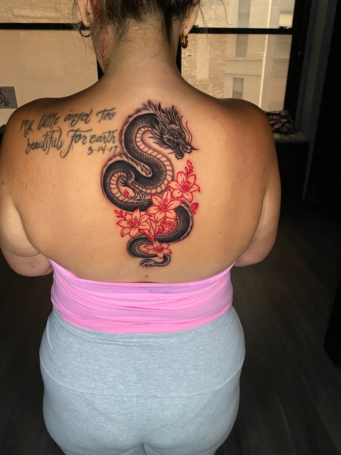 Dragon and flowers realism tattoo on the back by Kelan Mckenna