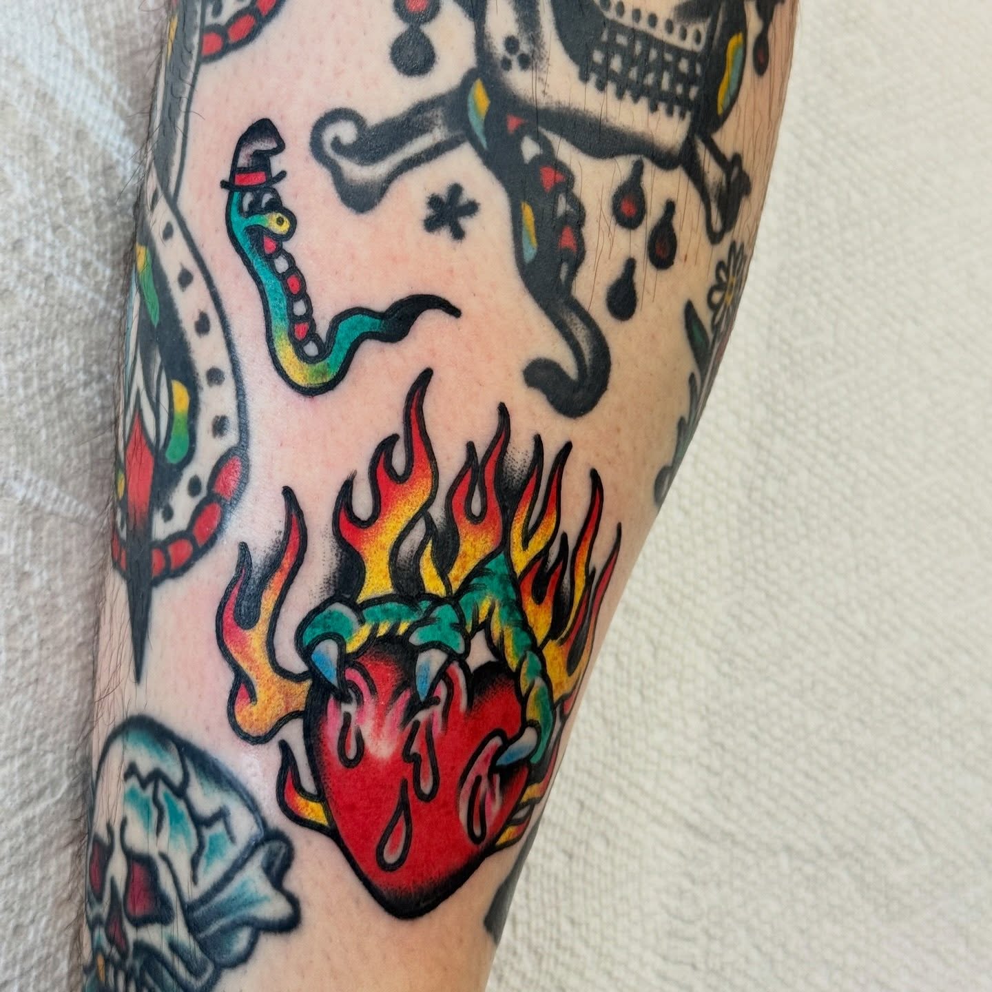 Flaming heart American traditional tattoo on the forearm by Kenny Kastro