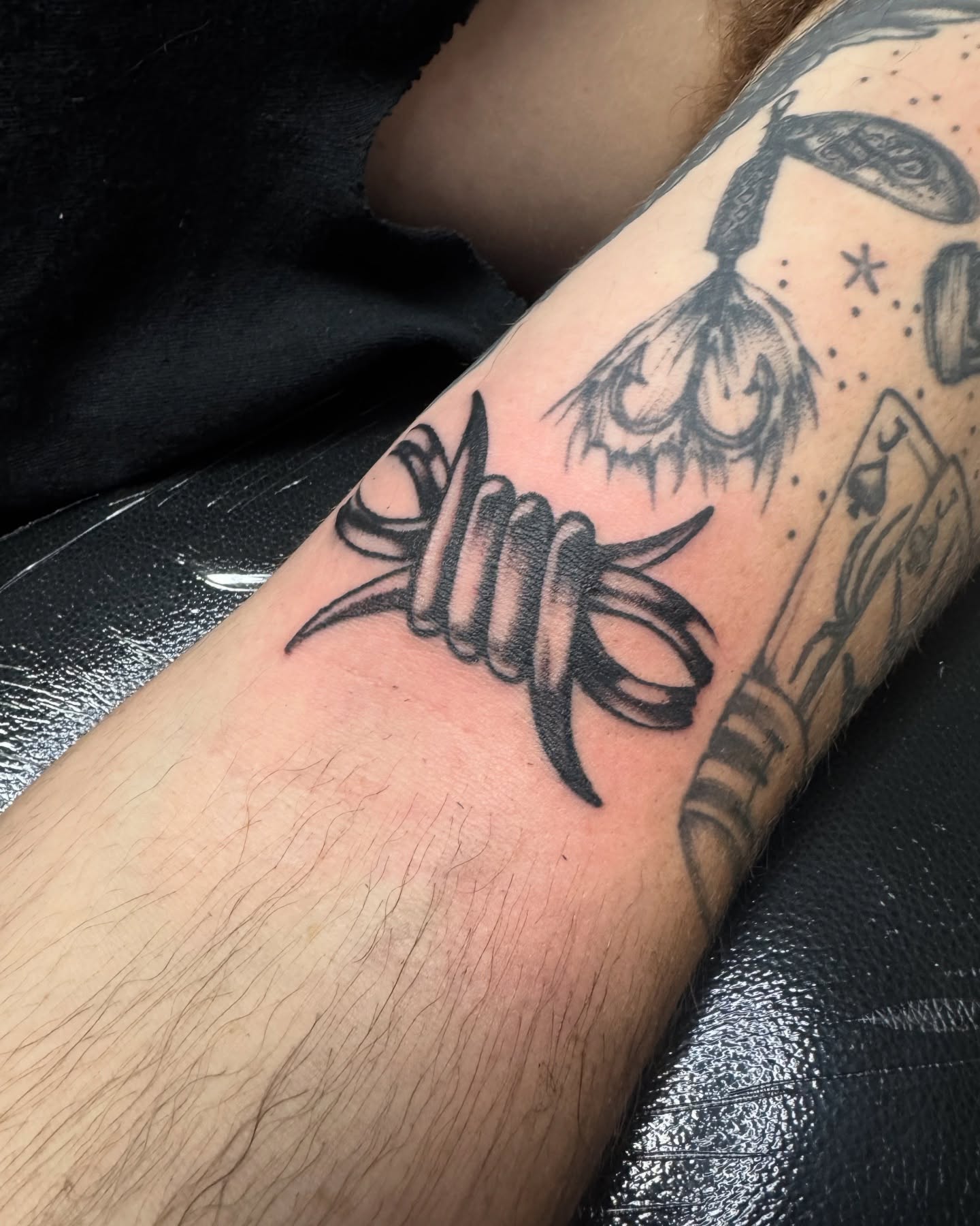 Barbed wire black and grey tattoo on the forearm by Saffron Florea, Tiffin, Ohio