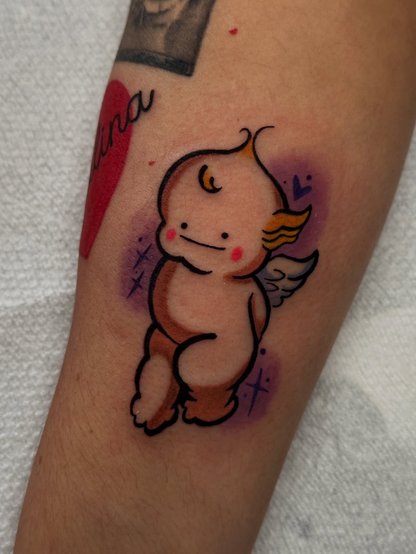 Angelic cherub watercolor tattoo on the forearm by Dustin Hughes