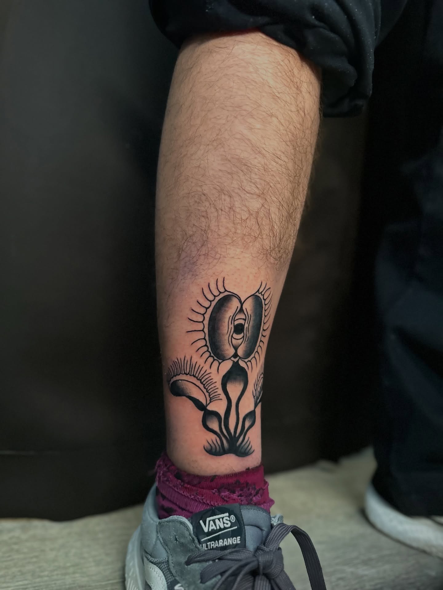 Ear with eyelashes black and grey tattoo on the forearm by Tyyler Santor (Tattoo Artist), Somerville, Massachusetts