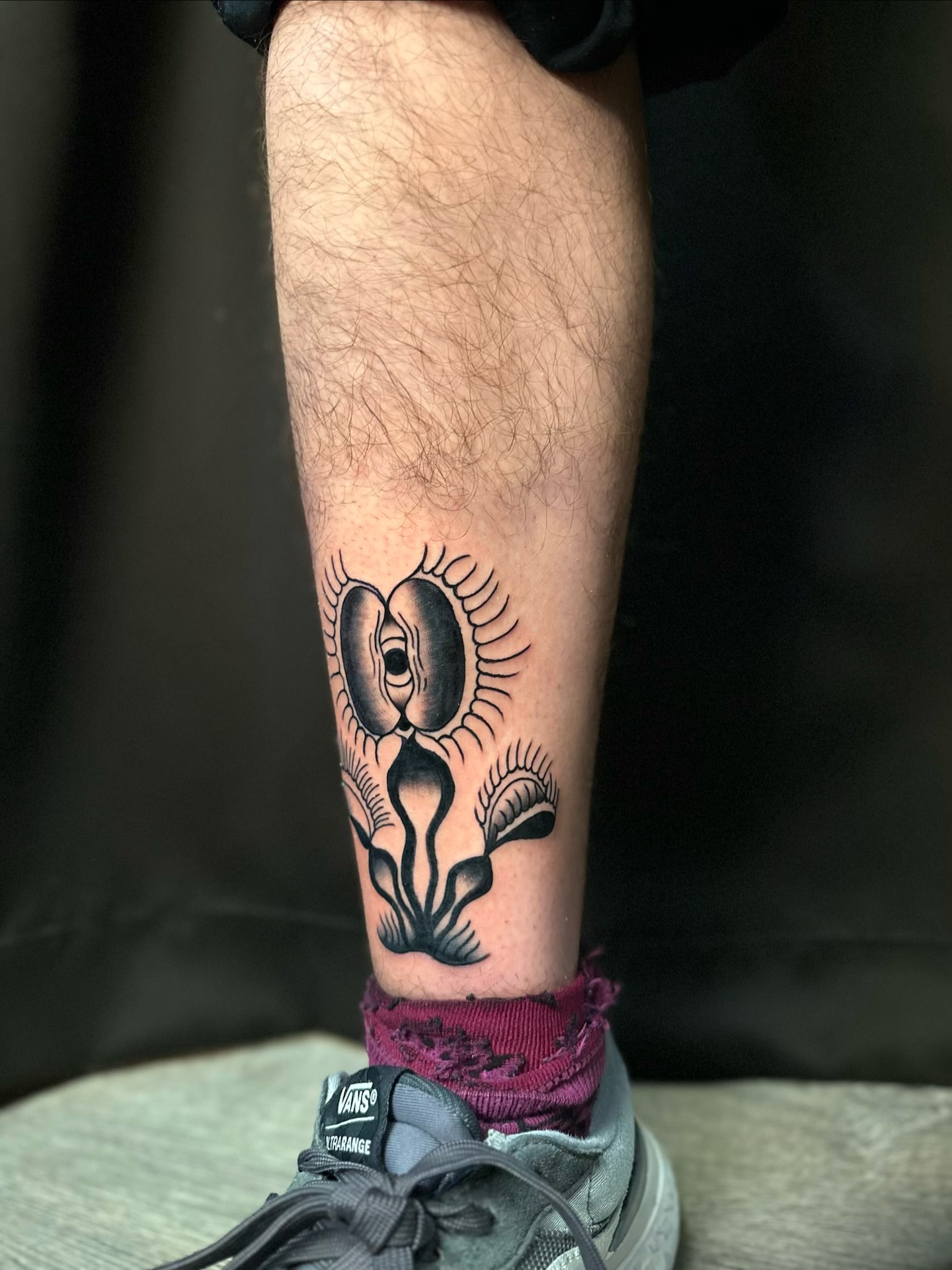 Abstract face black and grey tattoo on the calf by Tyyler Santor (Tattoo Artist), Somerville, Massachusetts