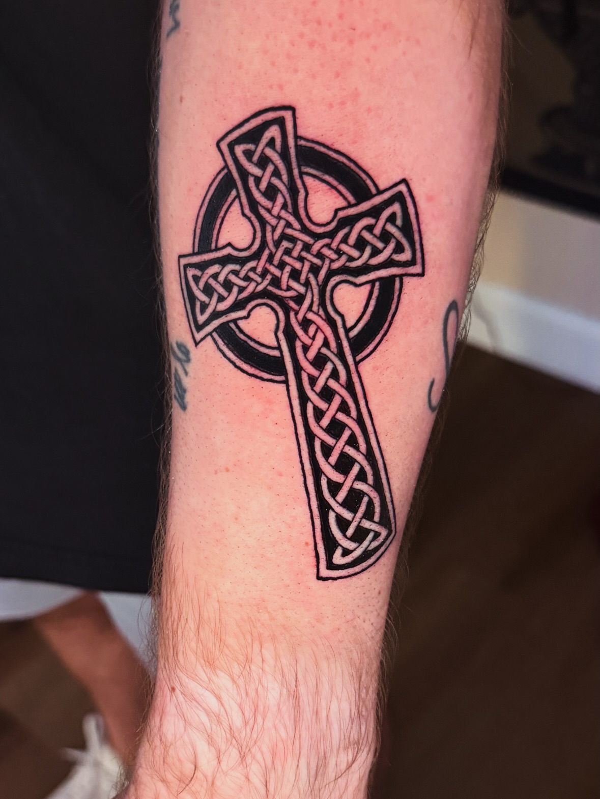 Celtic cross black and grey tattoo on the forearm by Drew’s Tattoos (NH)