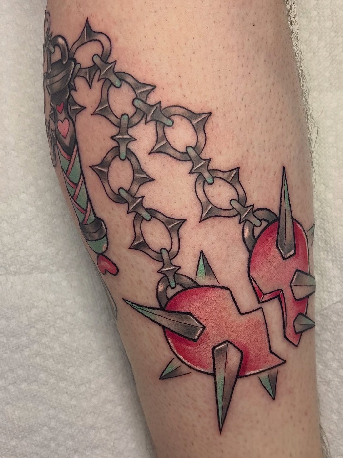 Spiked heart American traditional tattoo on the forearm by Lilac Rose