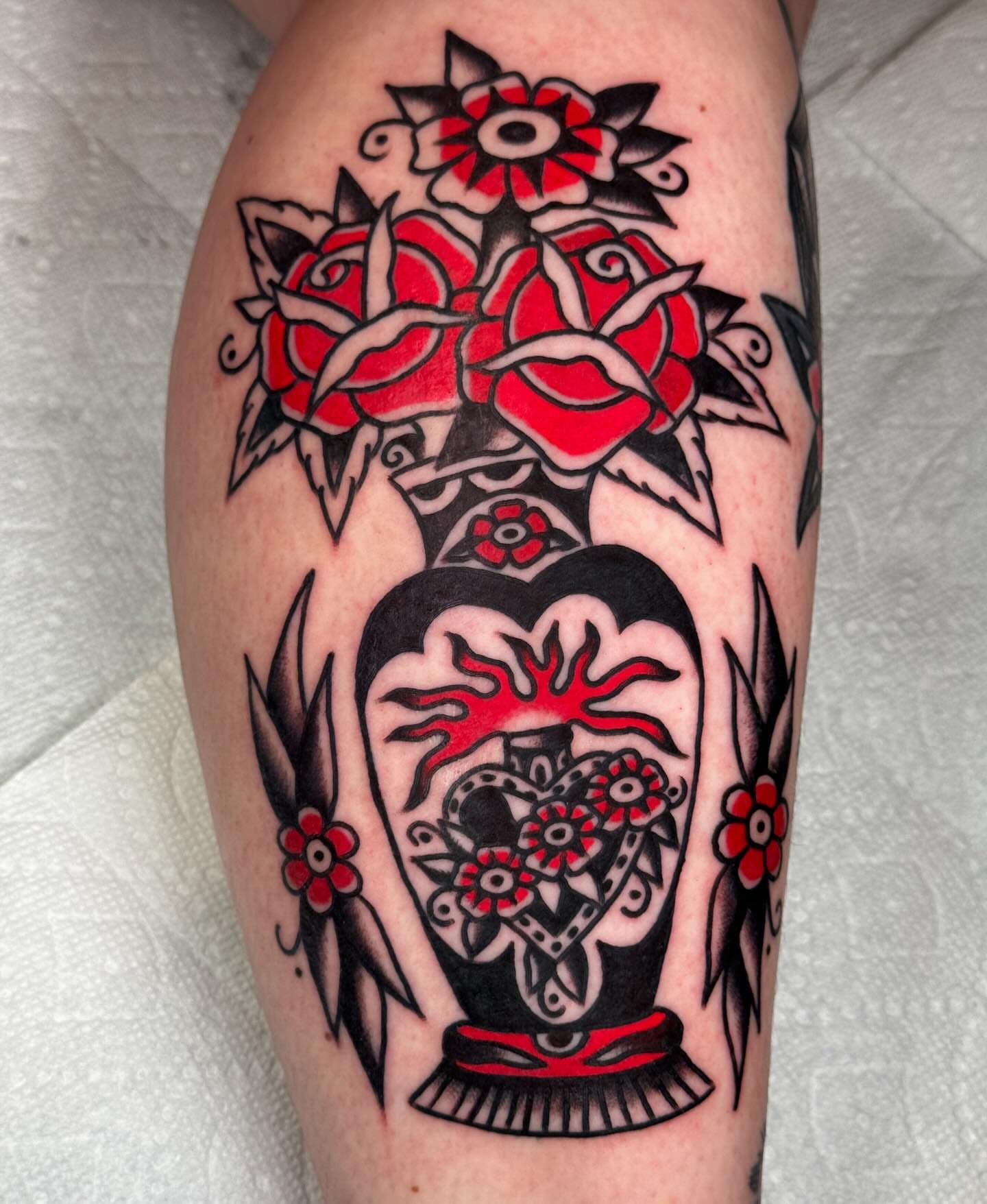 Heart with roses American traditional tattoo on the leg by JoJo Benton