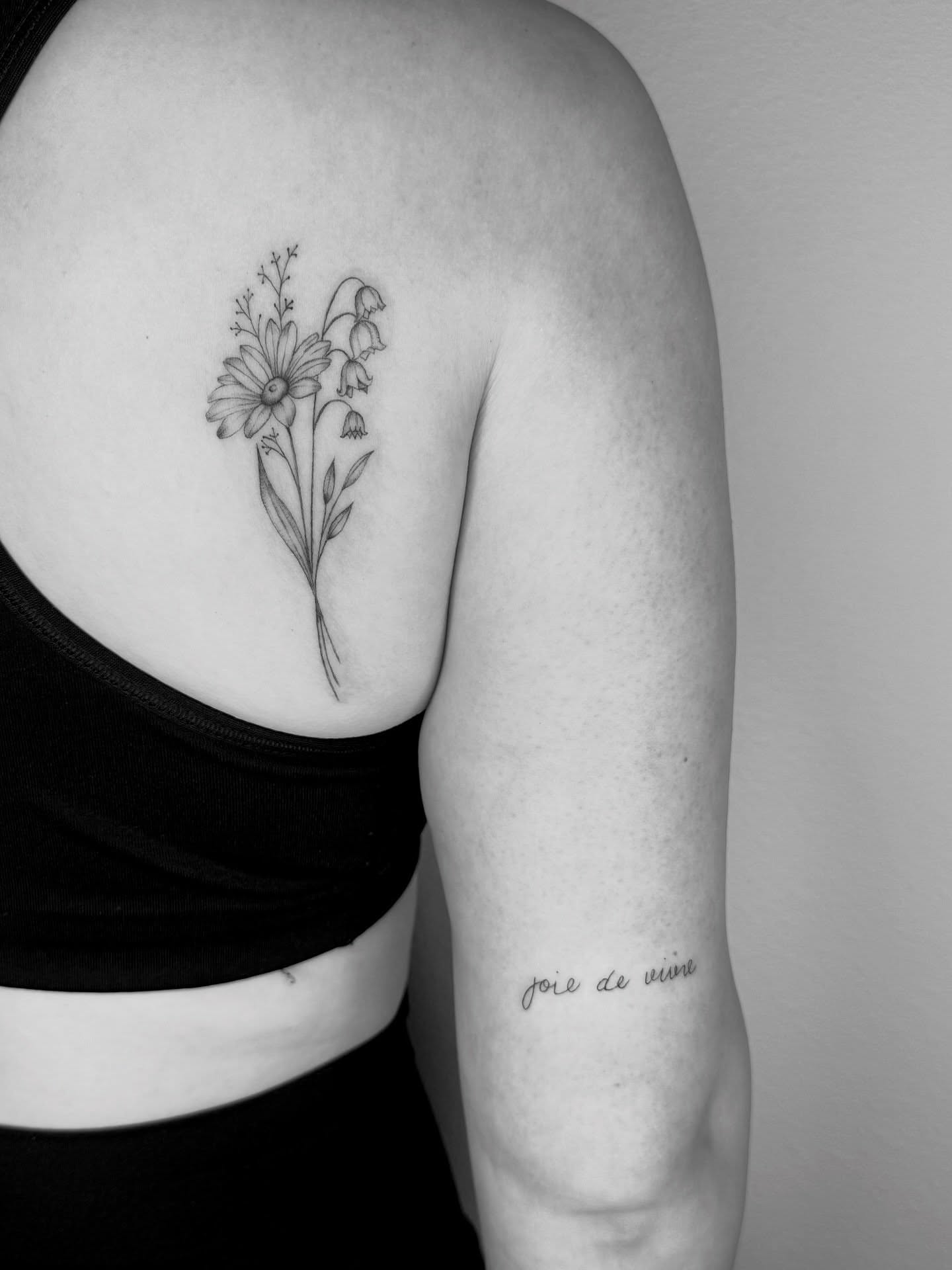 Floral bouquet realism tattoo on the shoulder by Ashley Limon