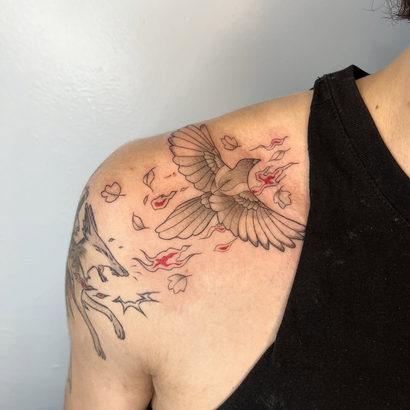 Bird and leaves black and grey tattoo on the shoulder by Iggy Montgomery (they