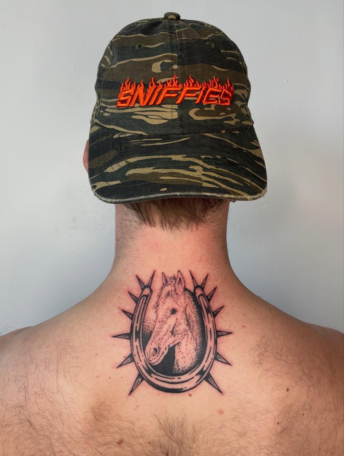 Horseshoe with horse head dotwork tattoo on the neck by Steven Sessler, San Francisco, California