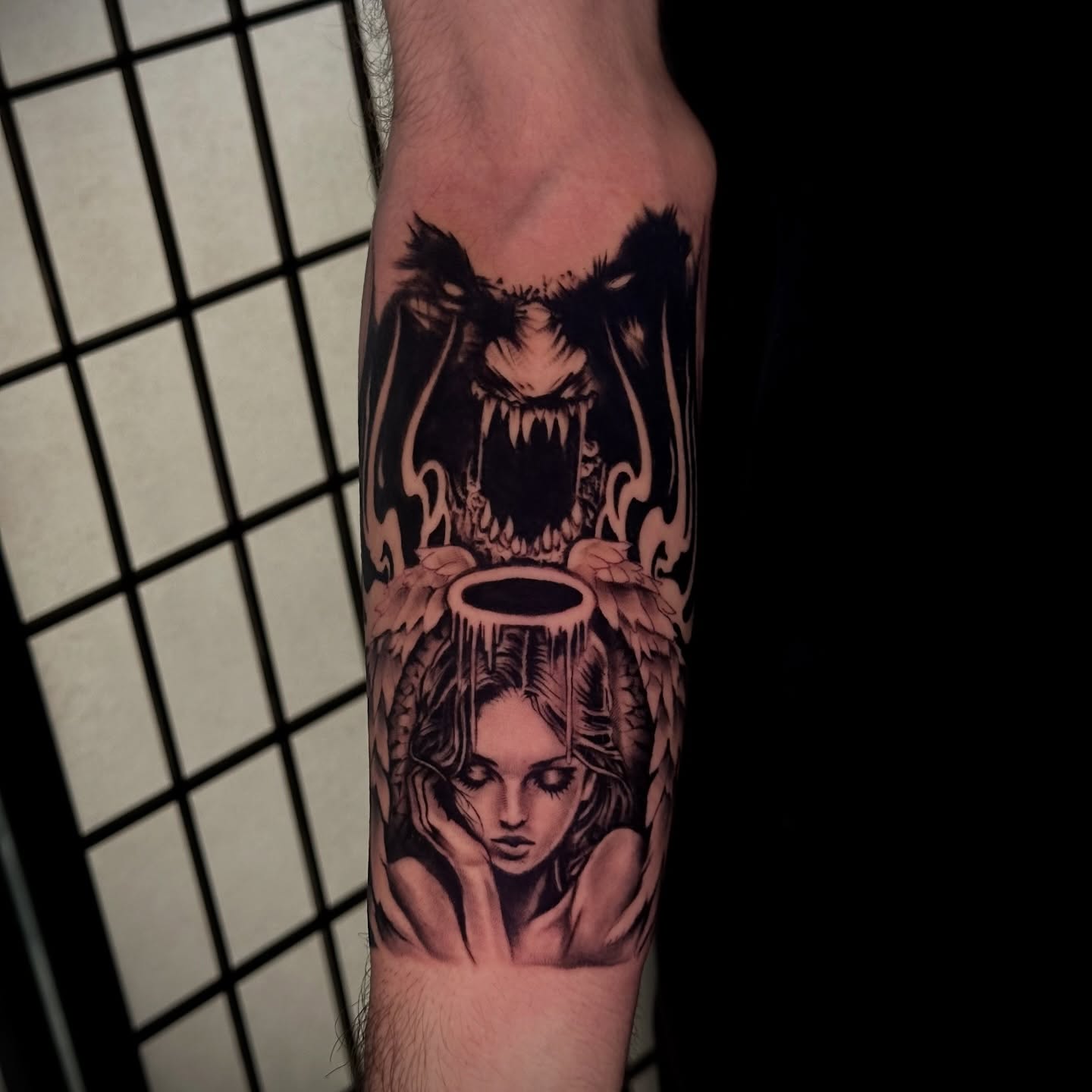 Demon and woman dark realism tattoo on the forearm by Robert Douglas