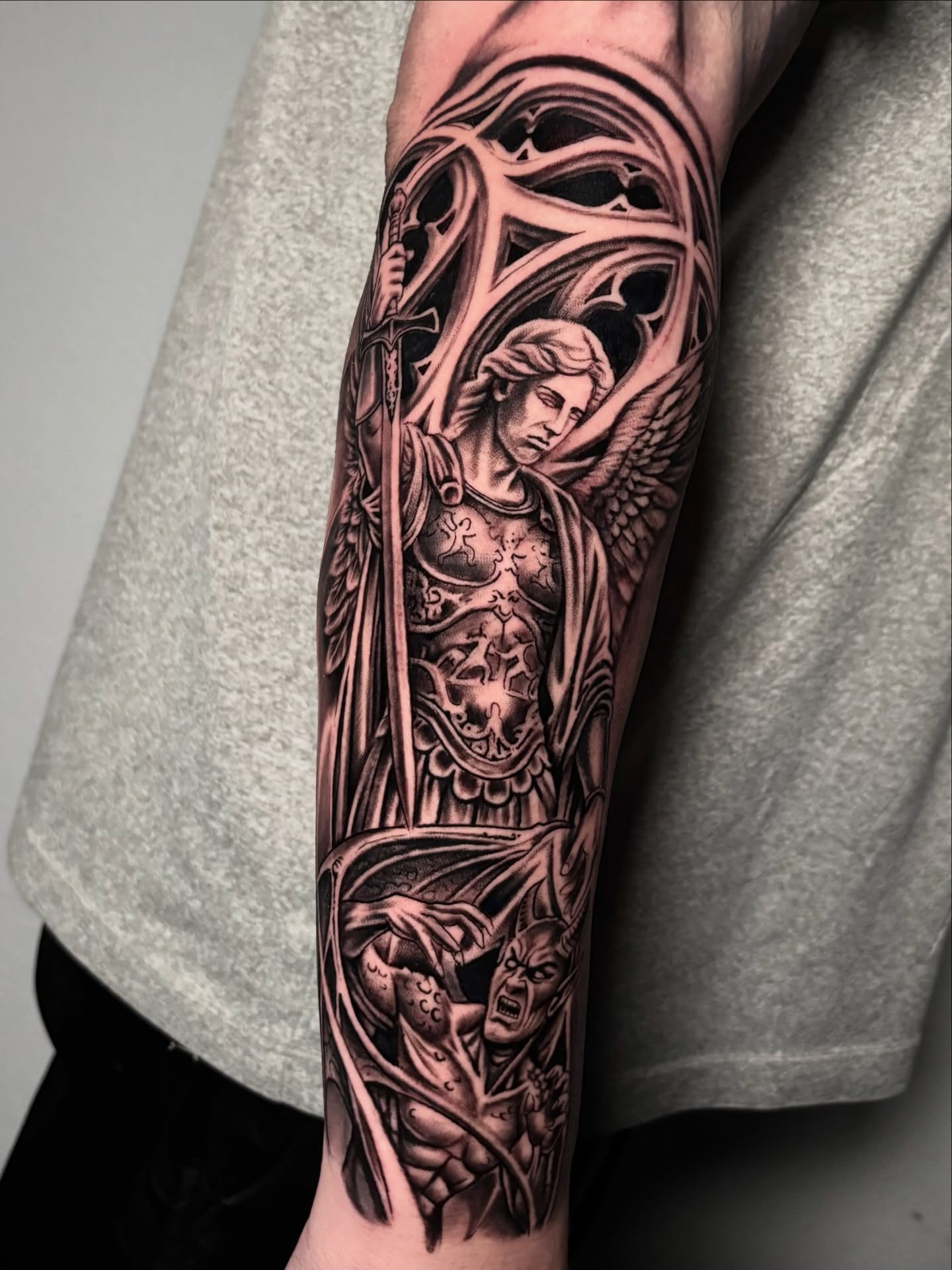 Angel and demon realism tattoo on the forearm by Dave