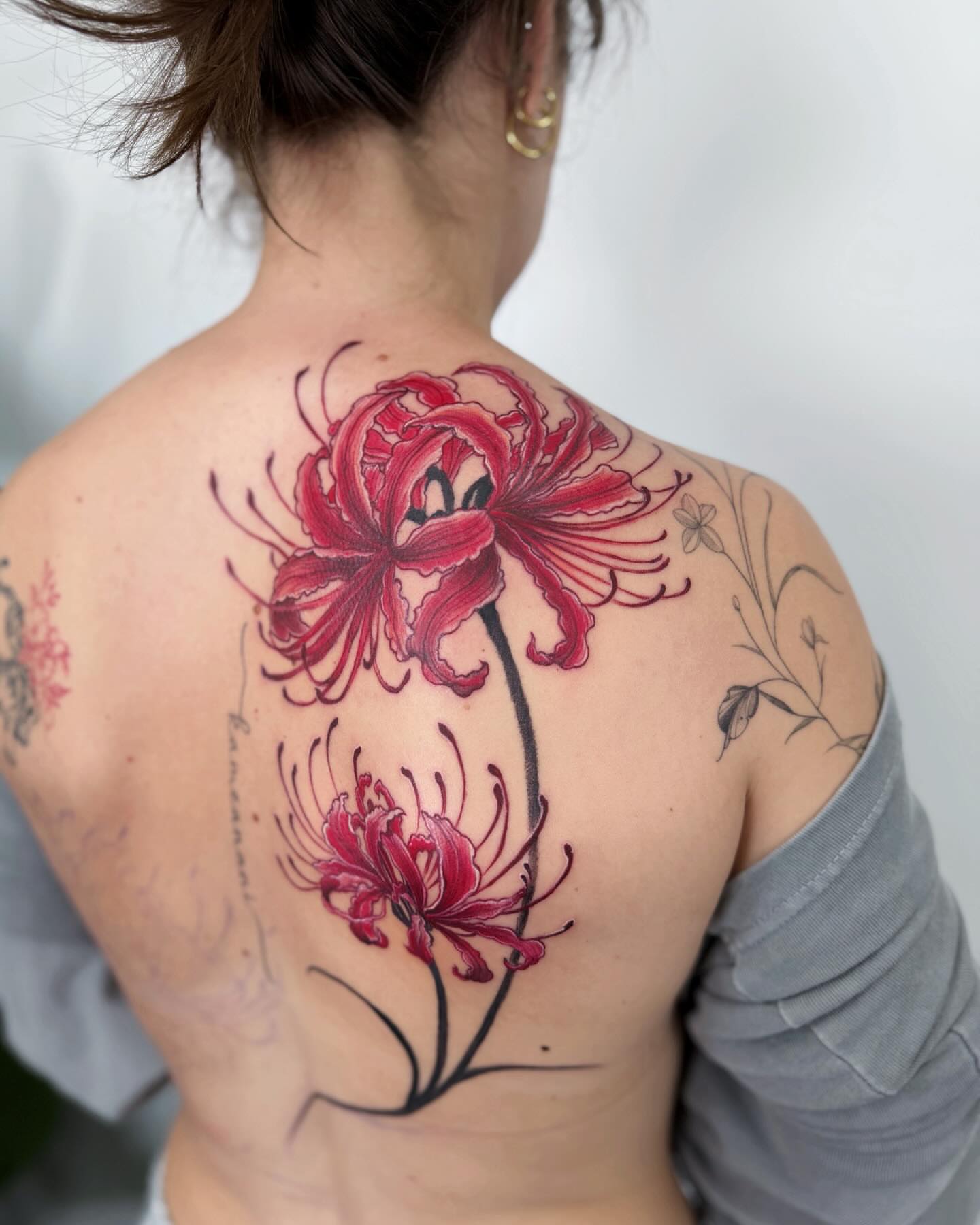 Red spider lilies realism tattoo on the back by Jiang_Tattooer